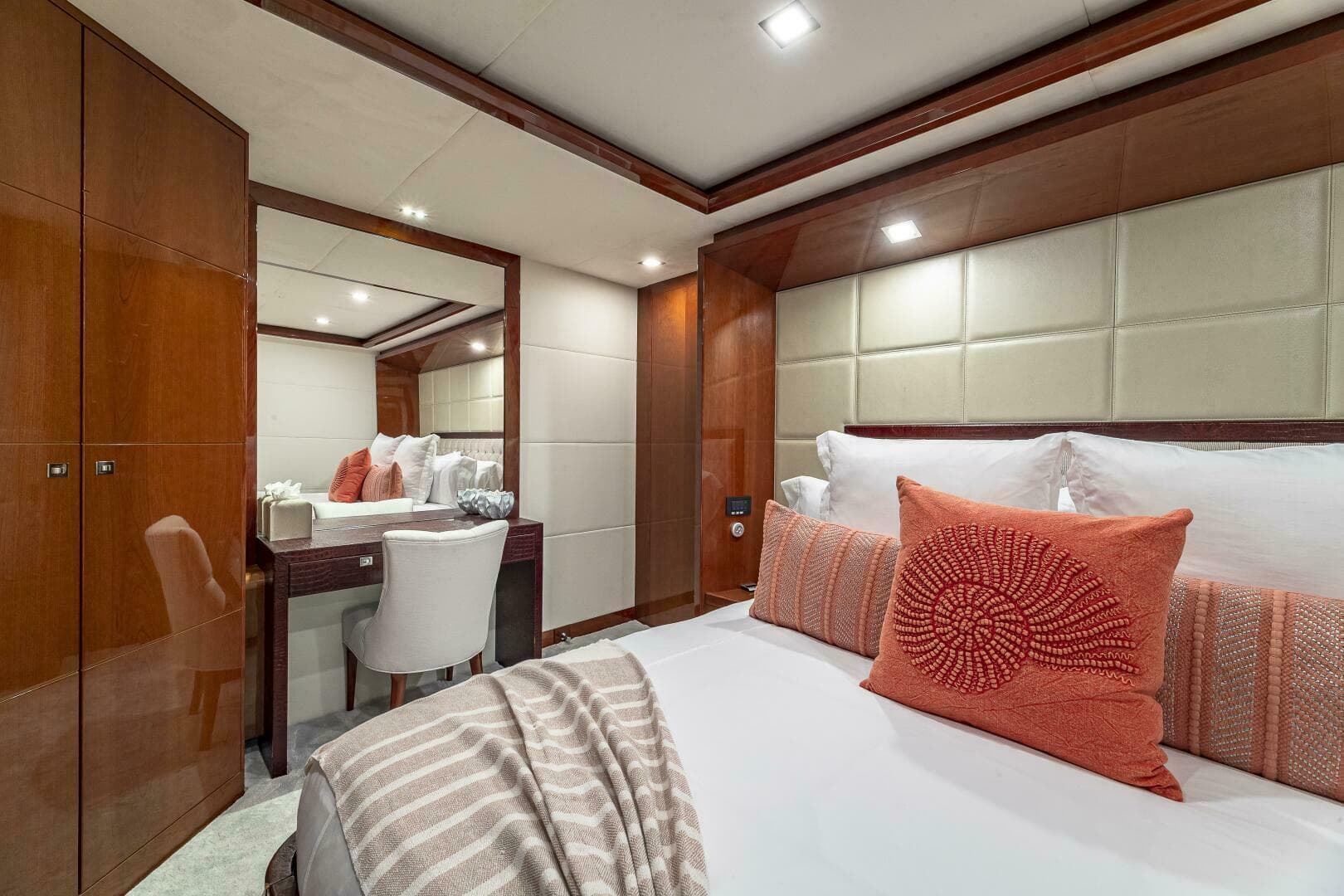 Luxurious bedroom interior of 2012 Princess 32M yacht with elegant decor and cozy bedding.