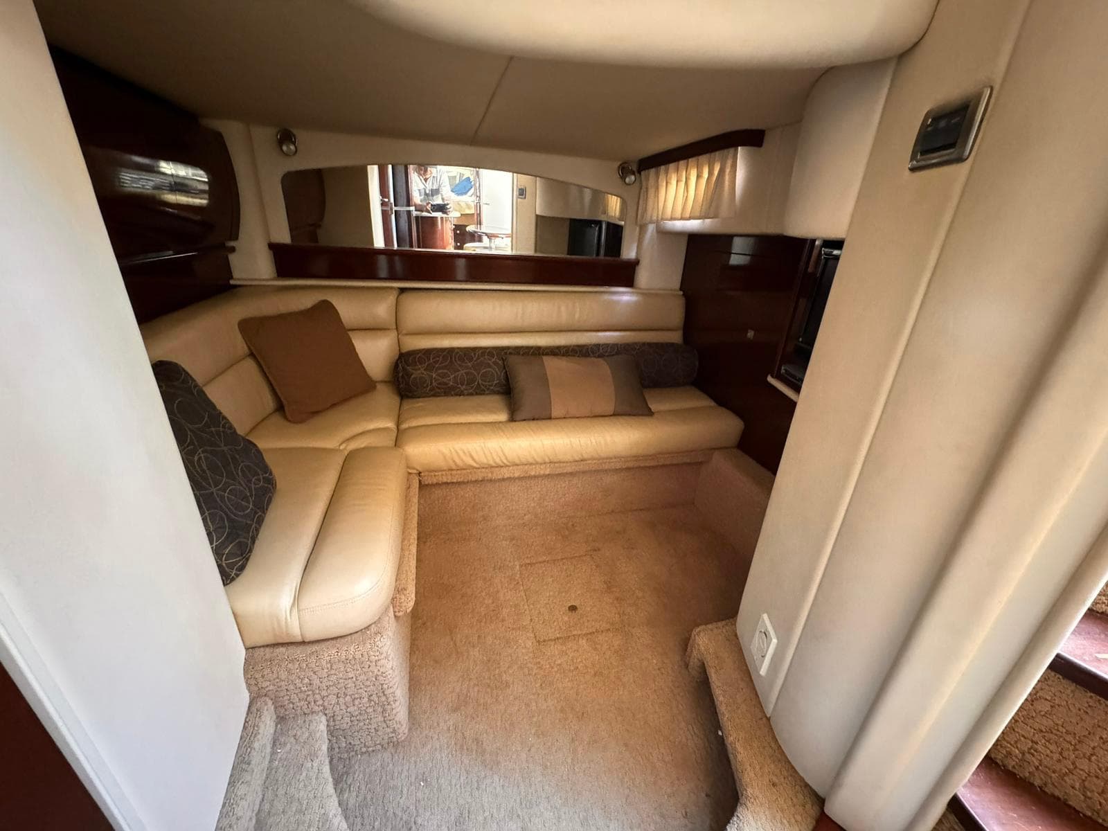 Luxurious interior of a 2008 Sea Ray Sundancer yacht with beige seating and cushions.