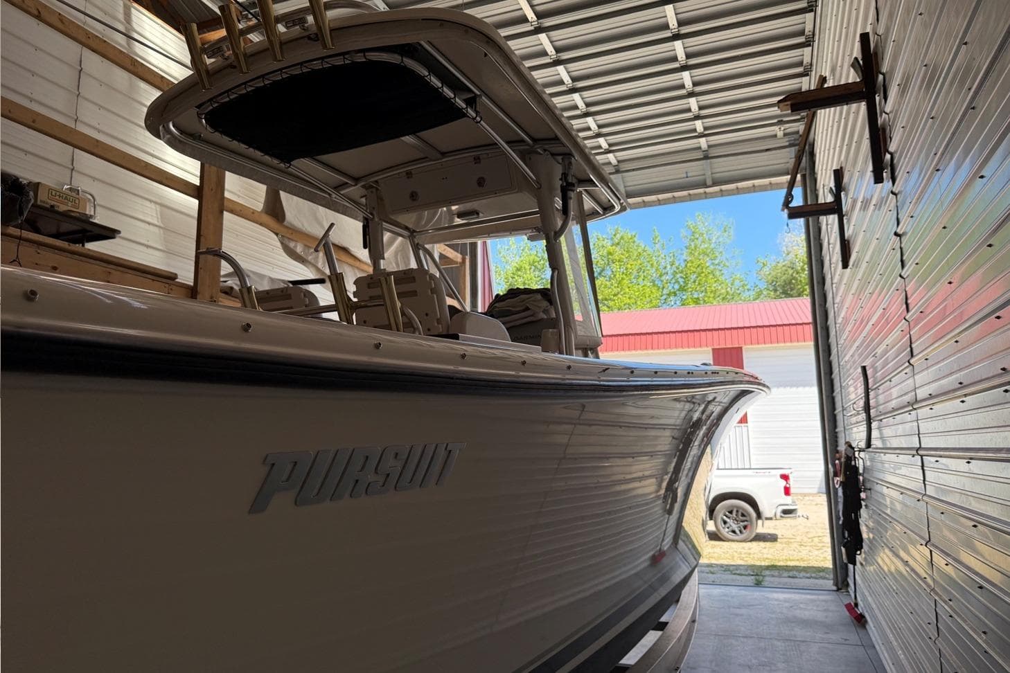 2007 Pursuit C 310 Center Console boat in a garage, side view.