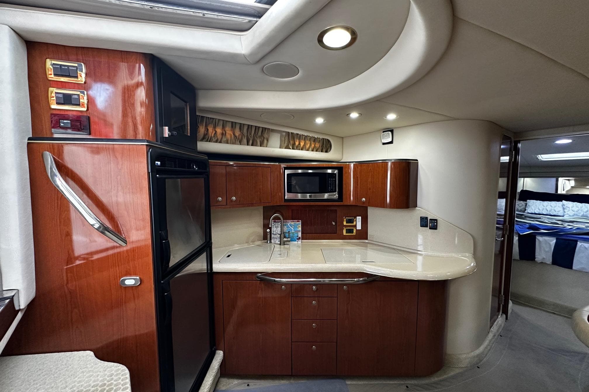 2001 Sea Ray 380 Sundancer yacht interior with kitchenette and modern amenities.