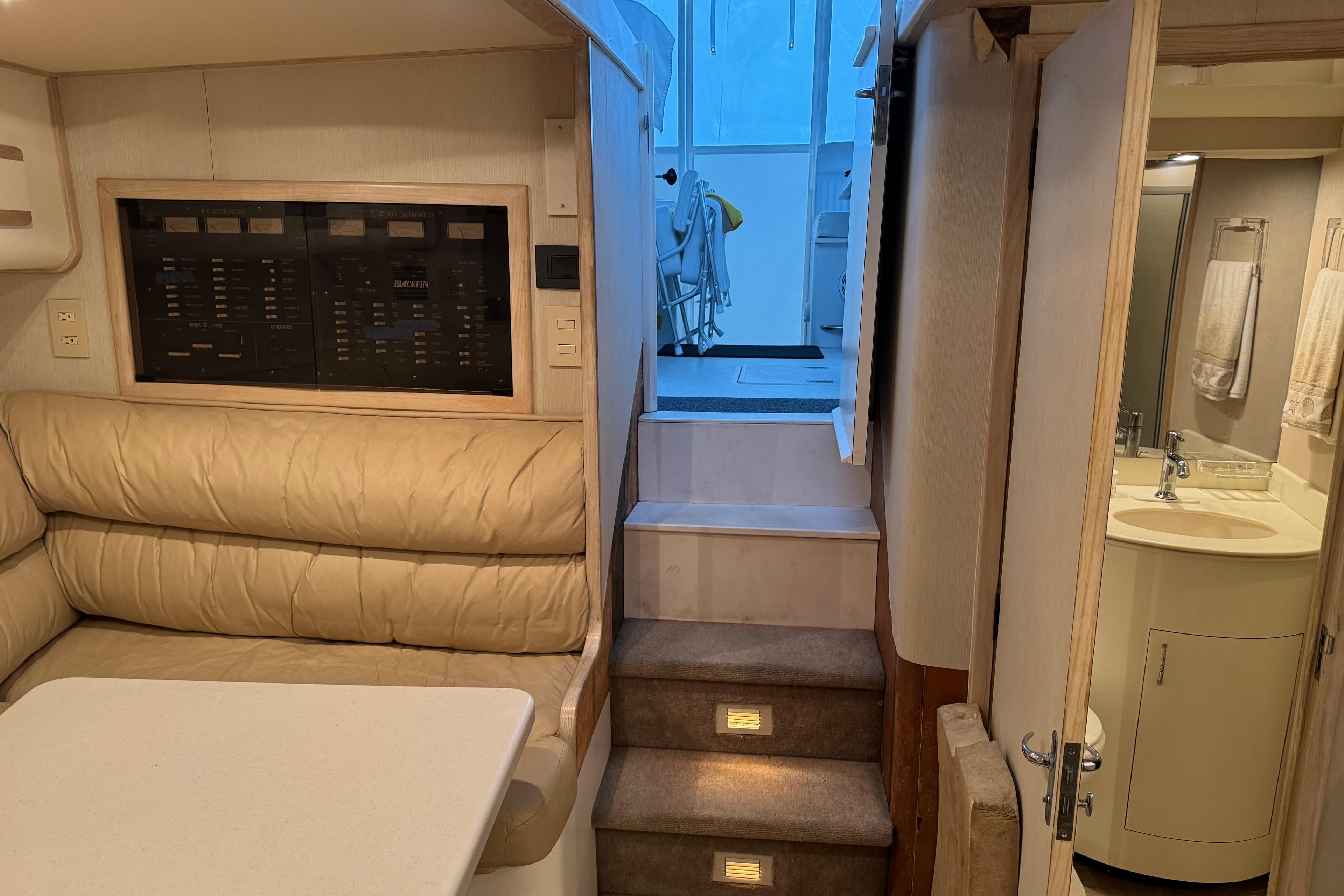 Interior of 1993 Blackfin 38 Combi yacht with seating, stairs, and bathroom.