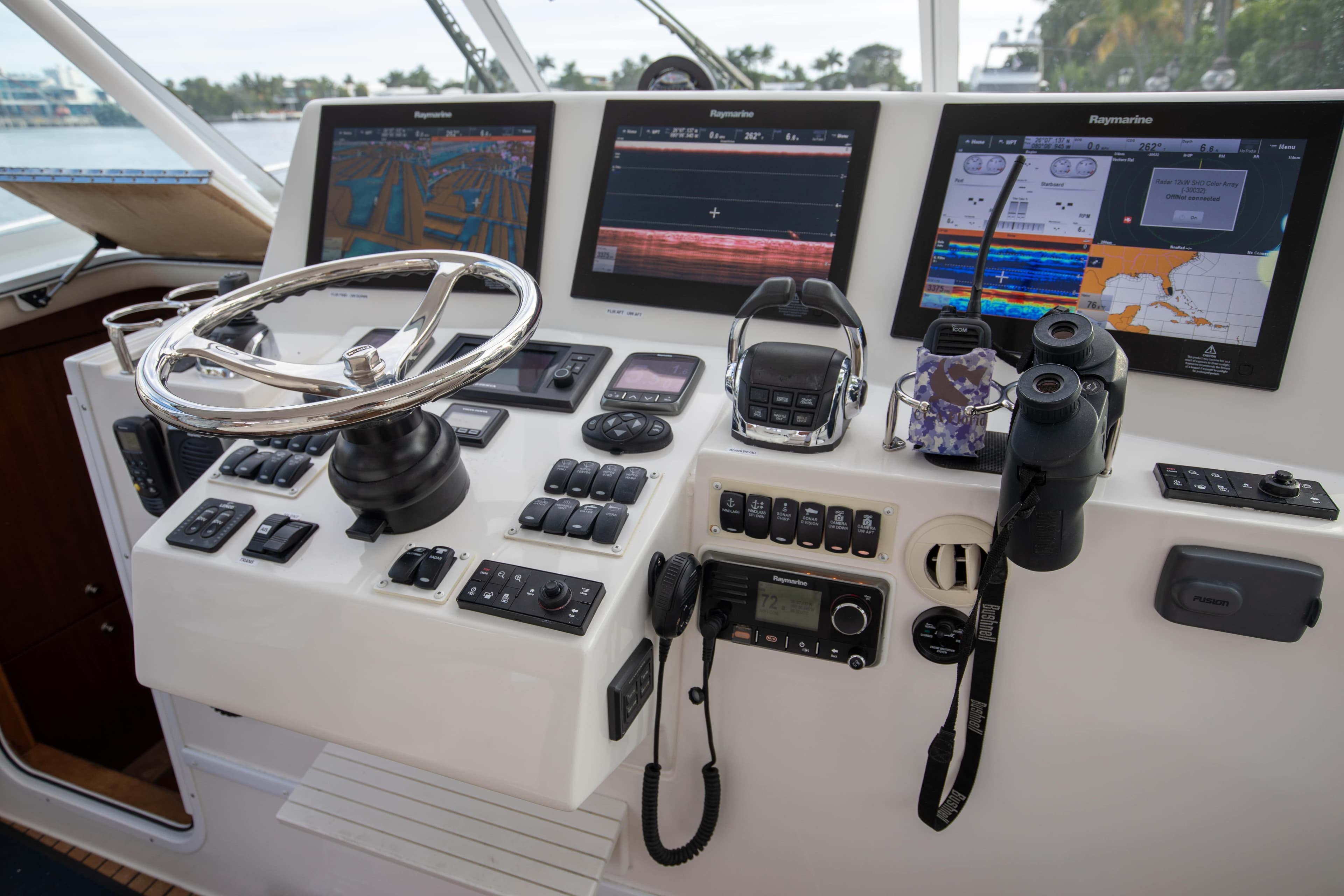 Control panel of 2015 Albemarle 360 Express Fisherman with navigation screens and steering wheel.