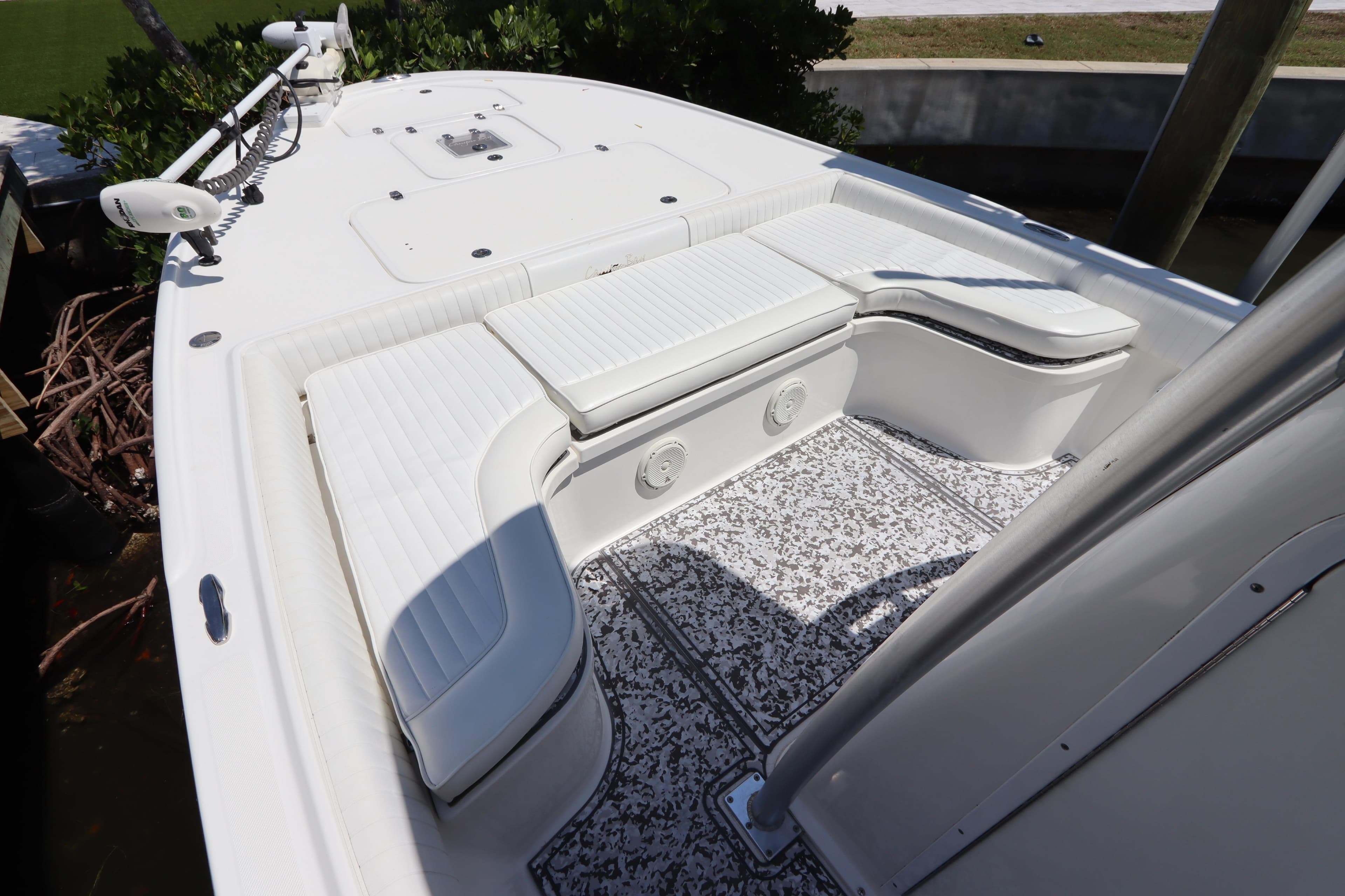 2014 Canyon Bay 2400 boat interior with white seating and patterned flooring.