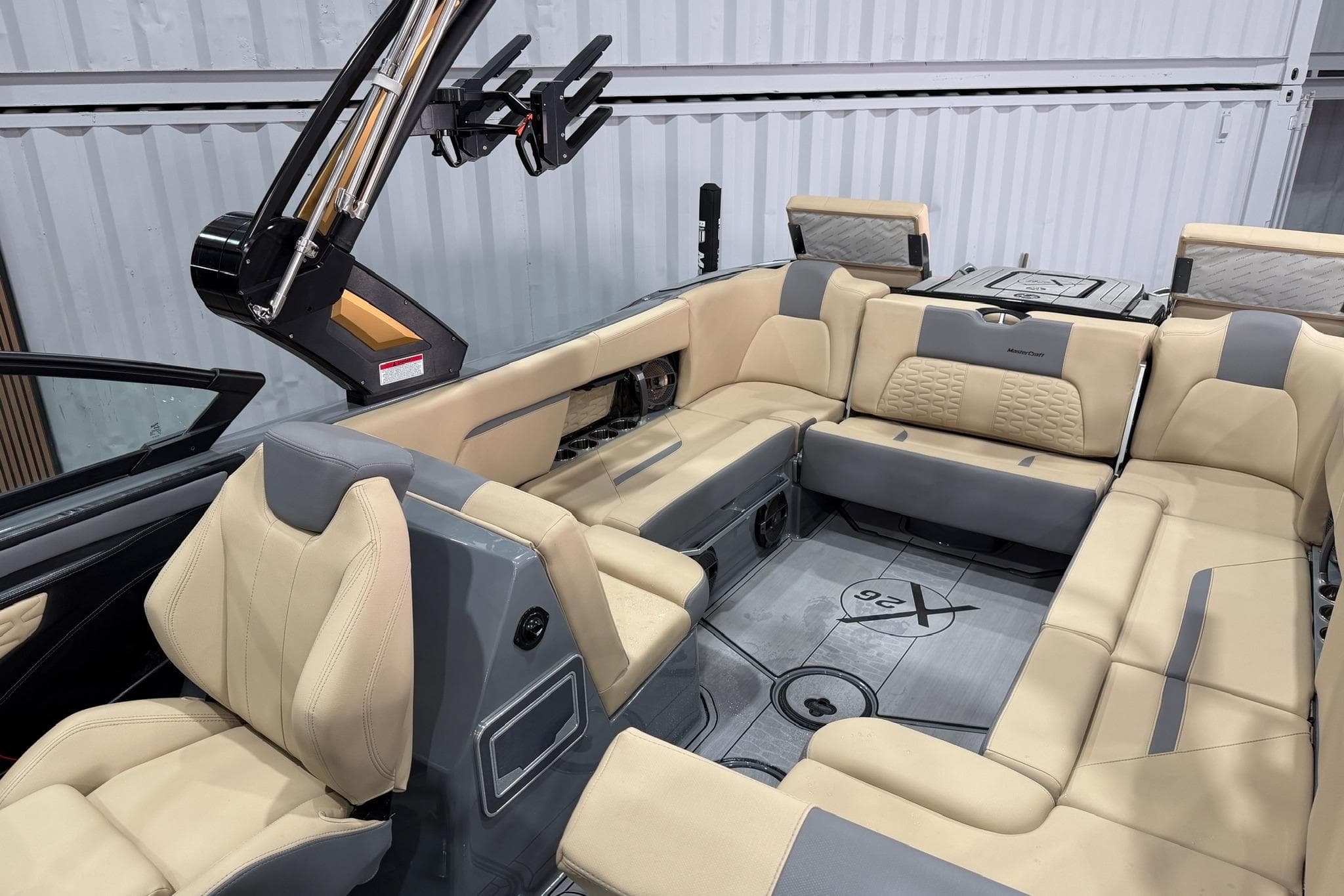 2022 MasterCraft X26 boat interior with beige and gray seating, showcasing luxury and comfort.
