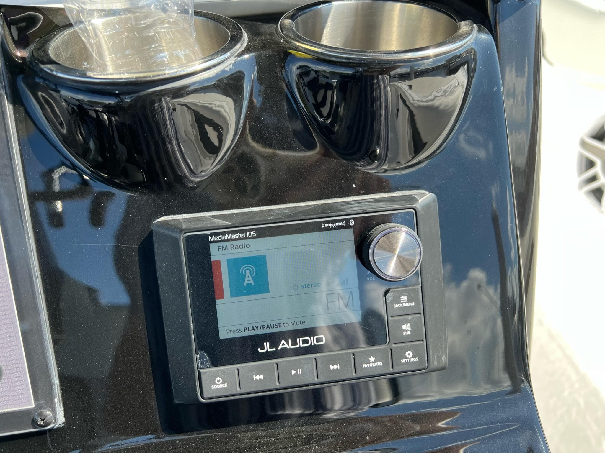 JL Audio system on 2023 Tidewater 320 CC Adventure boat dashboard with cup holders.