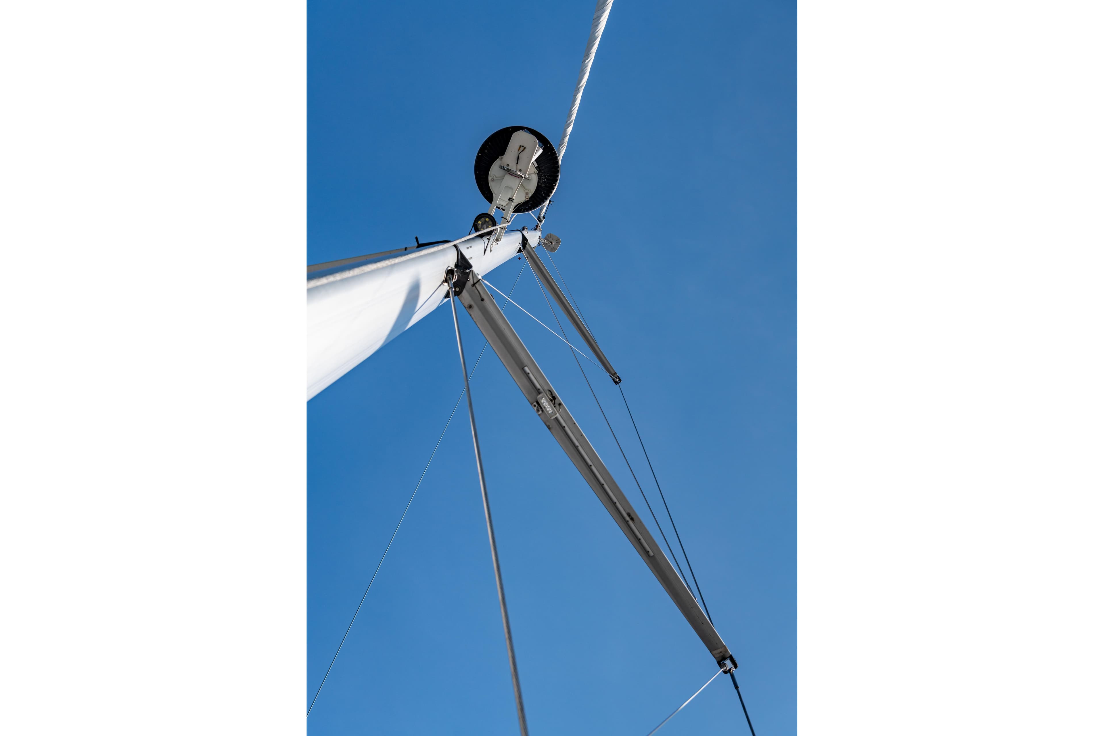 Sailboat mast of a 2007 Hunter 49 against a clear blue sky.