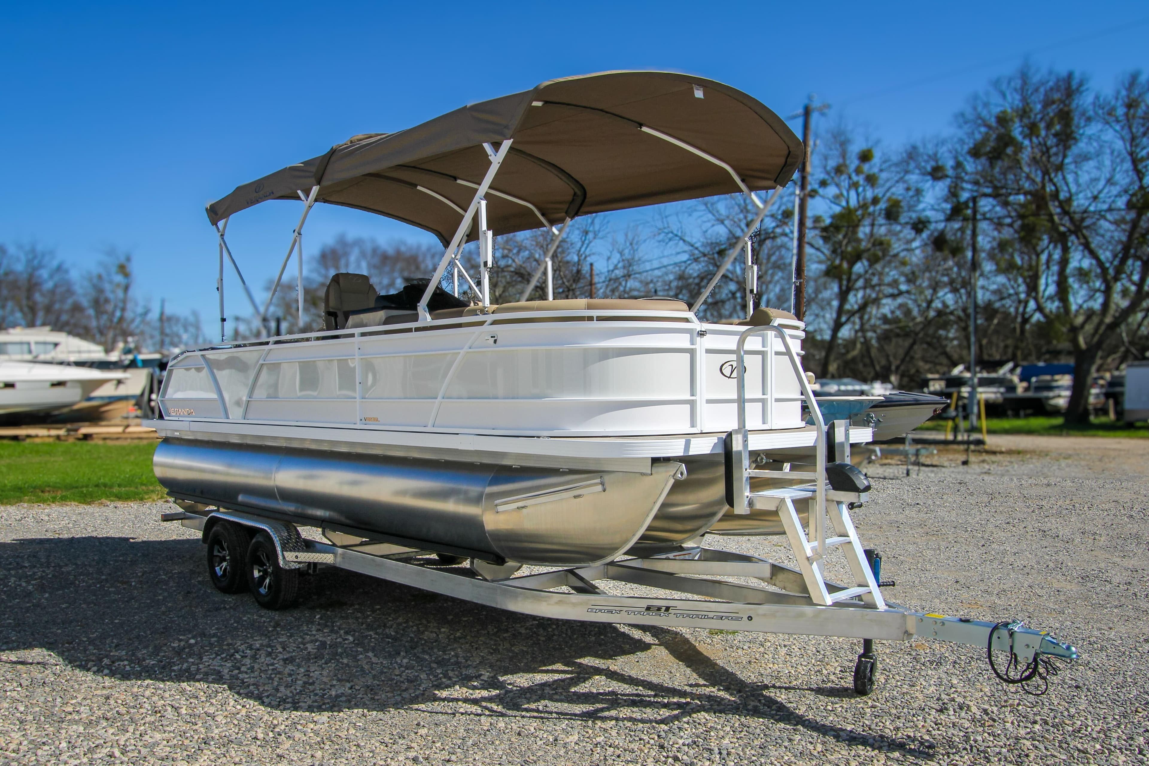 2026 Veranda VR235L pontoon boat on trailer, parked outdoors under clear blue sky.