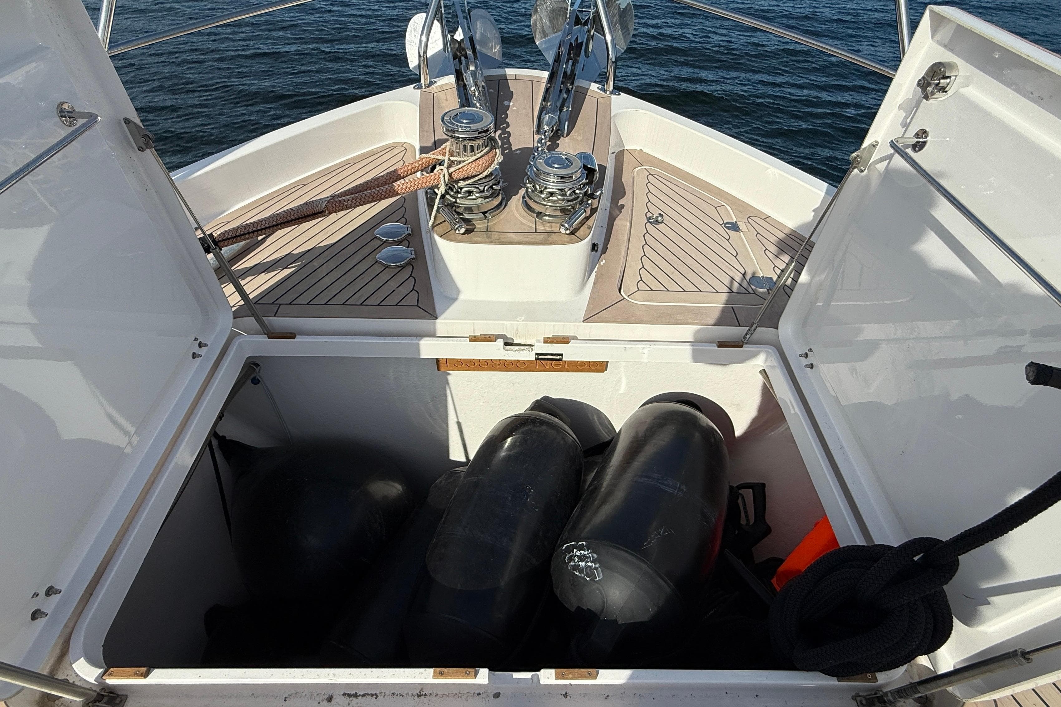 Open storage compartment on 2021 Elling E6 yacht with ropes and equipment.