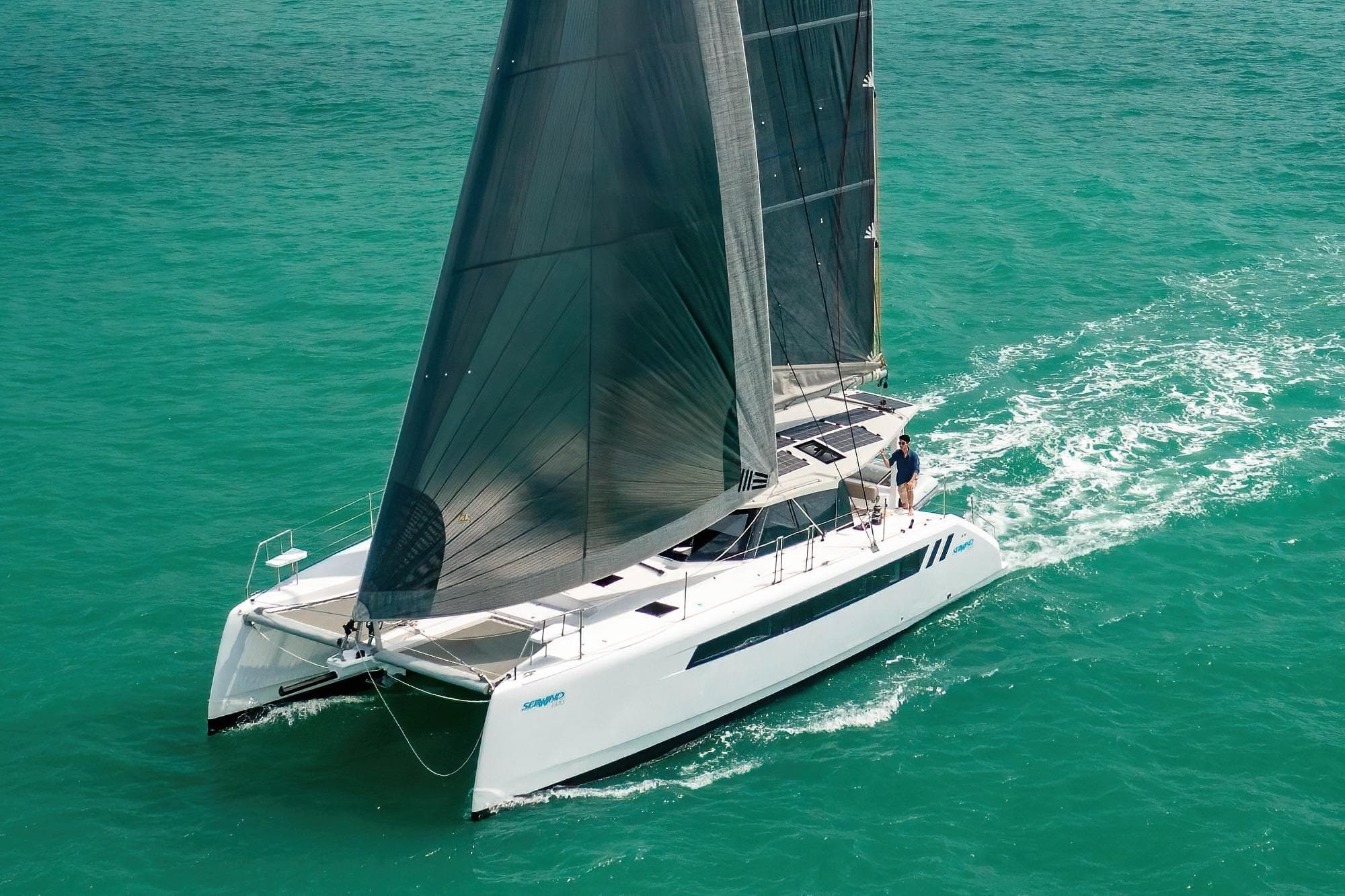 Sailing the turquoise waters, the 2026 Seawind 1370 catamaran showcases sleek design and performance.