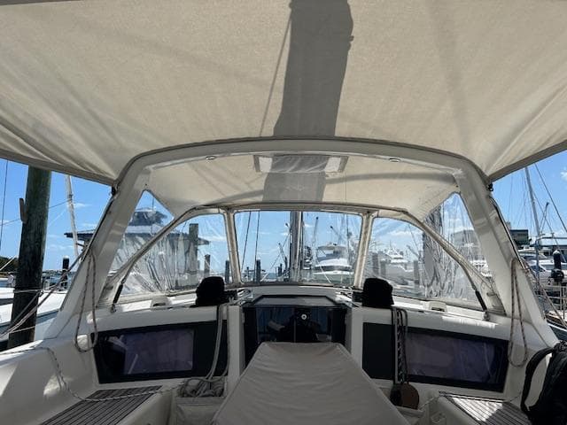 Cockpit view of a 2013 Beneteau 48 sailboat docked at a marina.