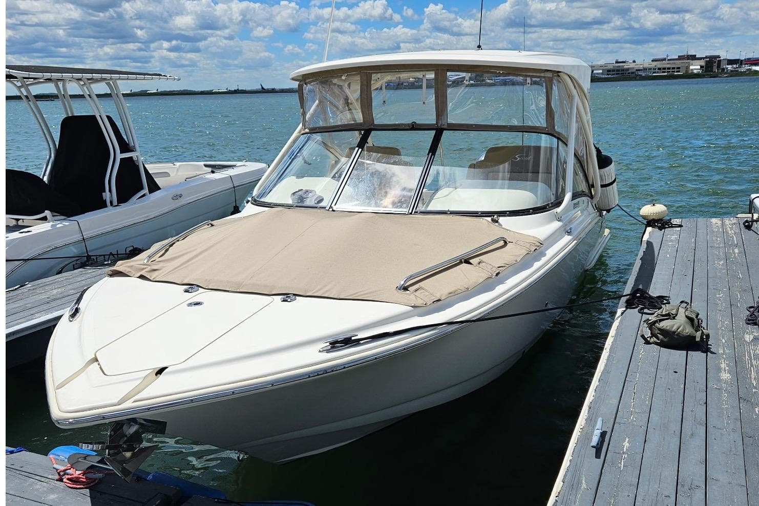 2020 Scout 255 Dorado boat docked on a sunny day with clear skies.