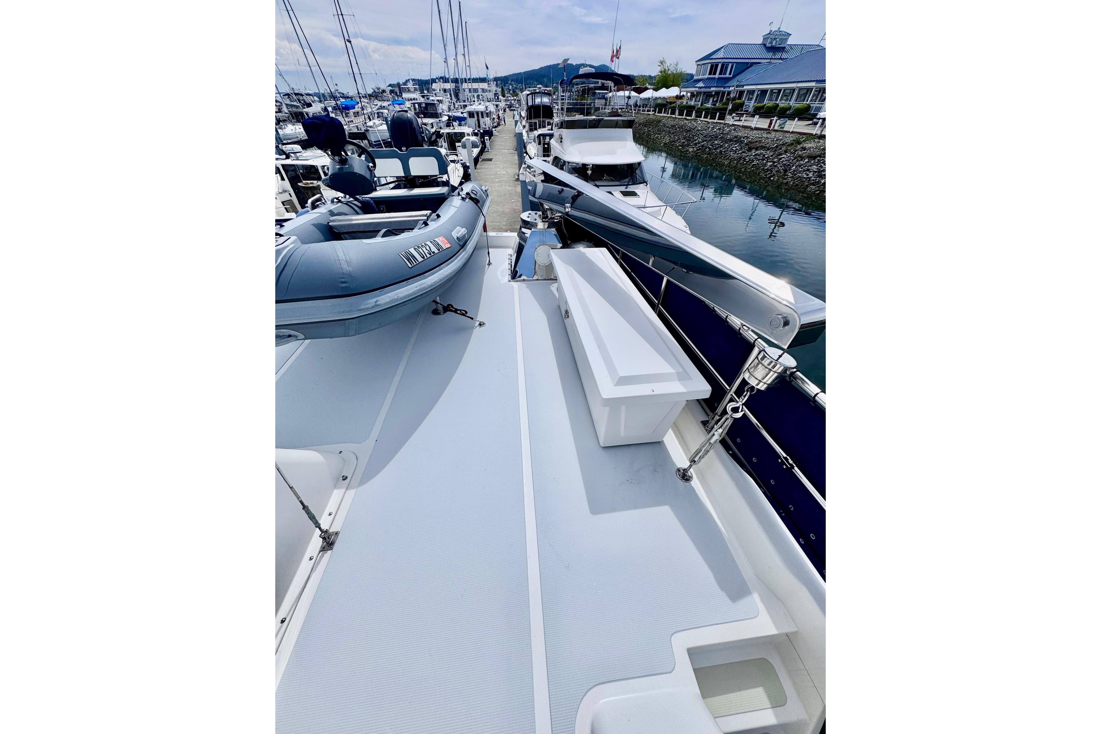 Nordhavn 50 yacht deck, 2000 model, docked with inflatable boat and marina view.