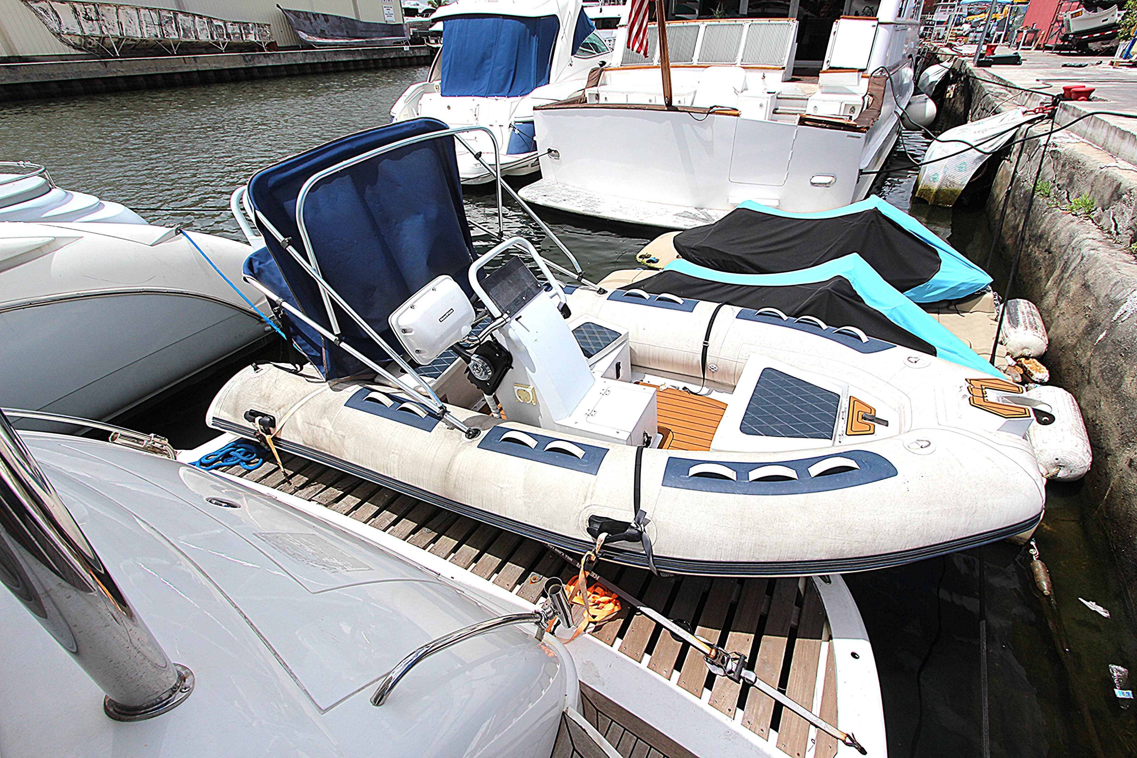 2001 Sunseeker Predator 56 yacht docked with inflatable boat on deck.