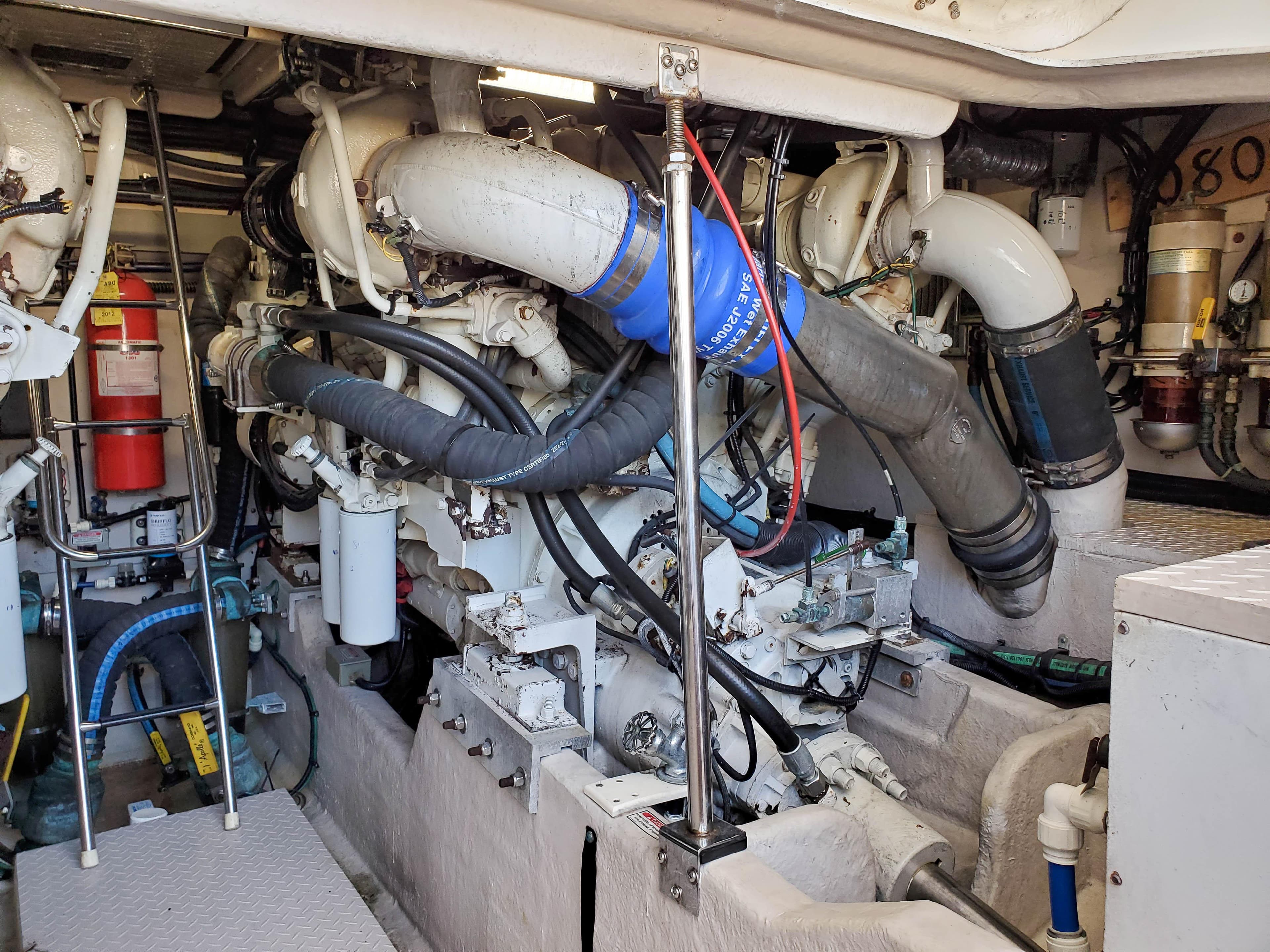 Engine room of a 1997 Sea Ray 580 Super Sun Sport yacht, showcasing complex machinery and piping.