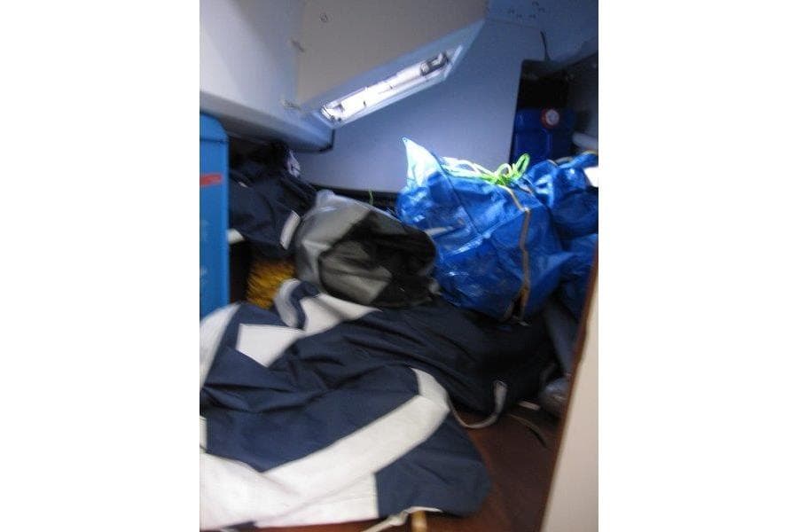 Interior of 2022 Jeanneau Sun Odyssey 349 with stored sailing gear and equipment.