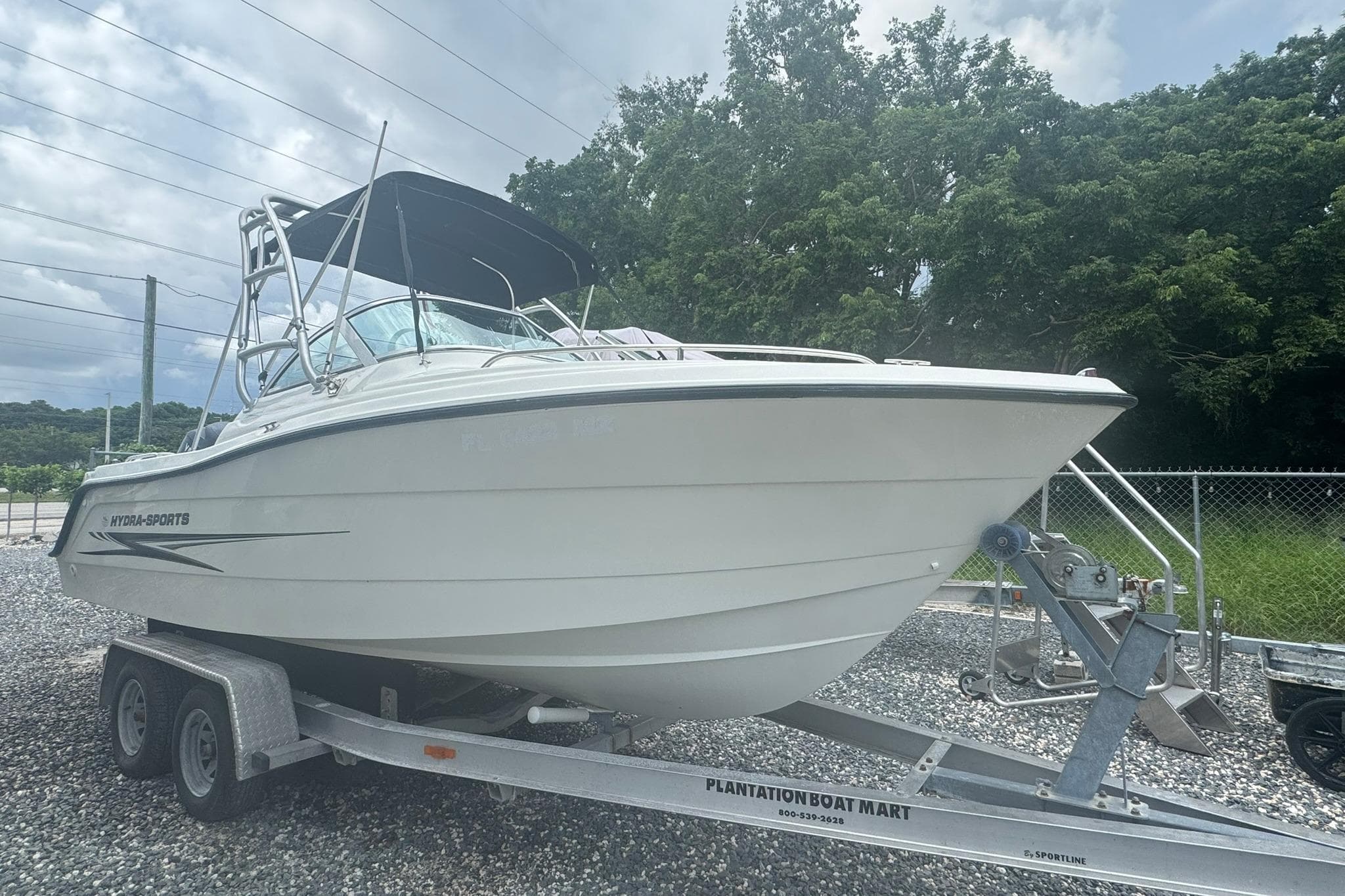 2004 Hydra-Sports Lightning 202 DC boat on trailer, parked outdoors.
