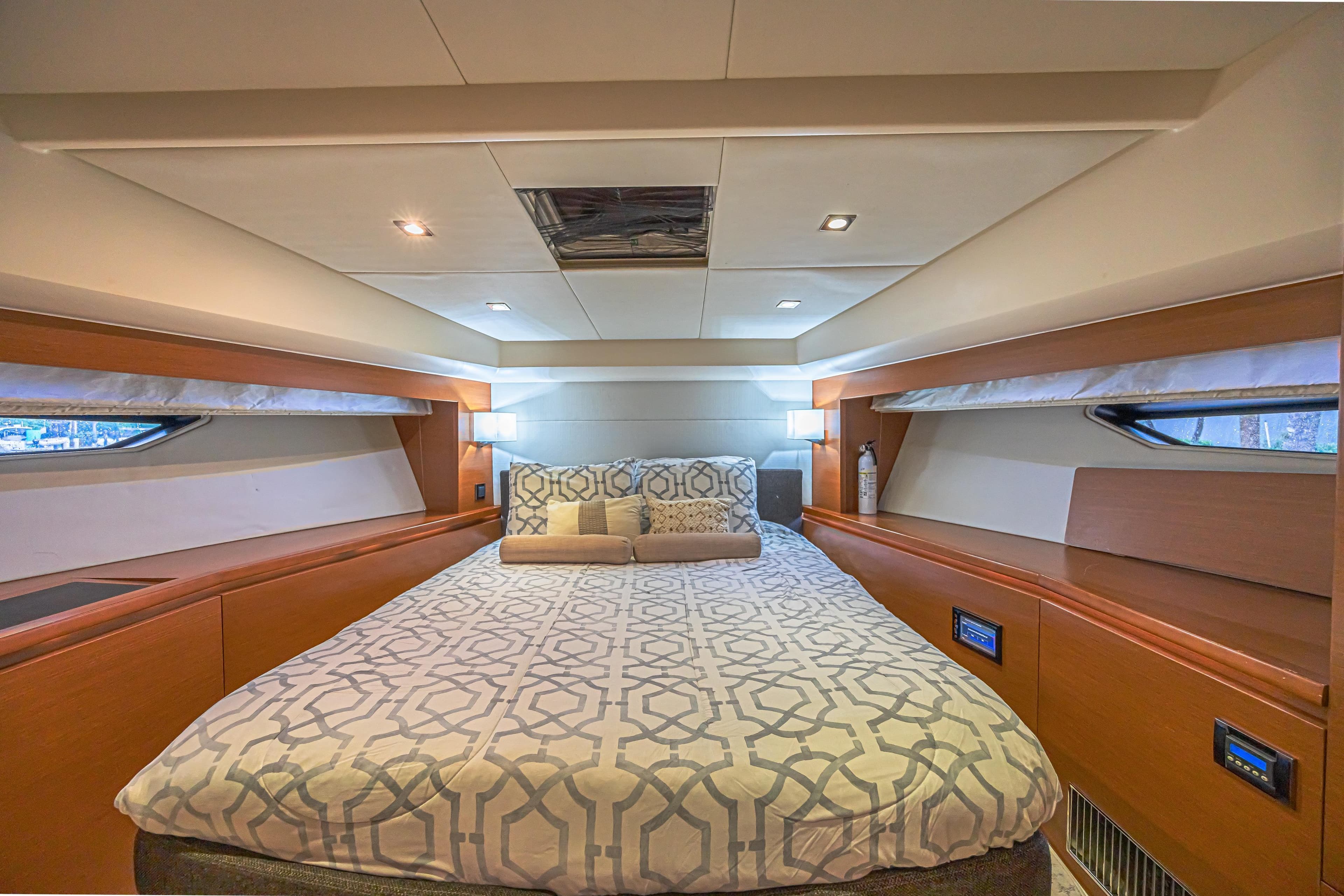 Luxurious bedroom interior of 2013 Prestige 550 S yacht with modern design and cozy bedding.