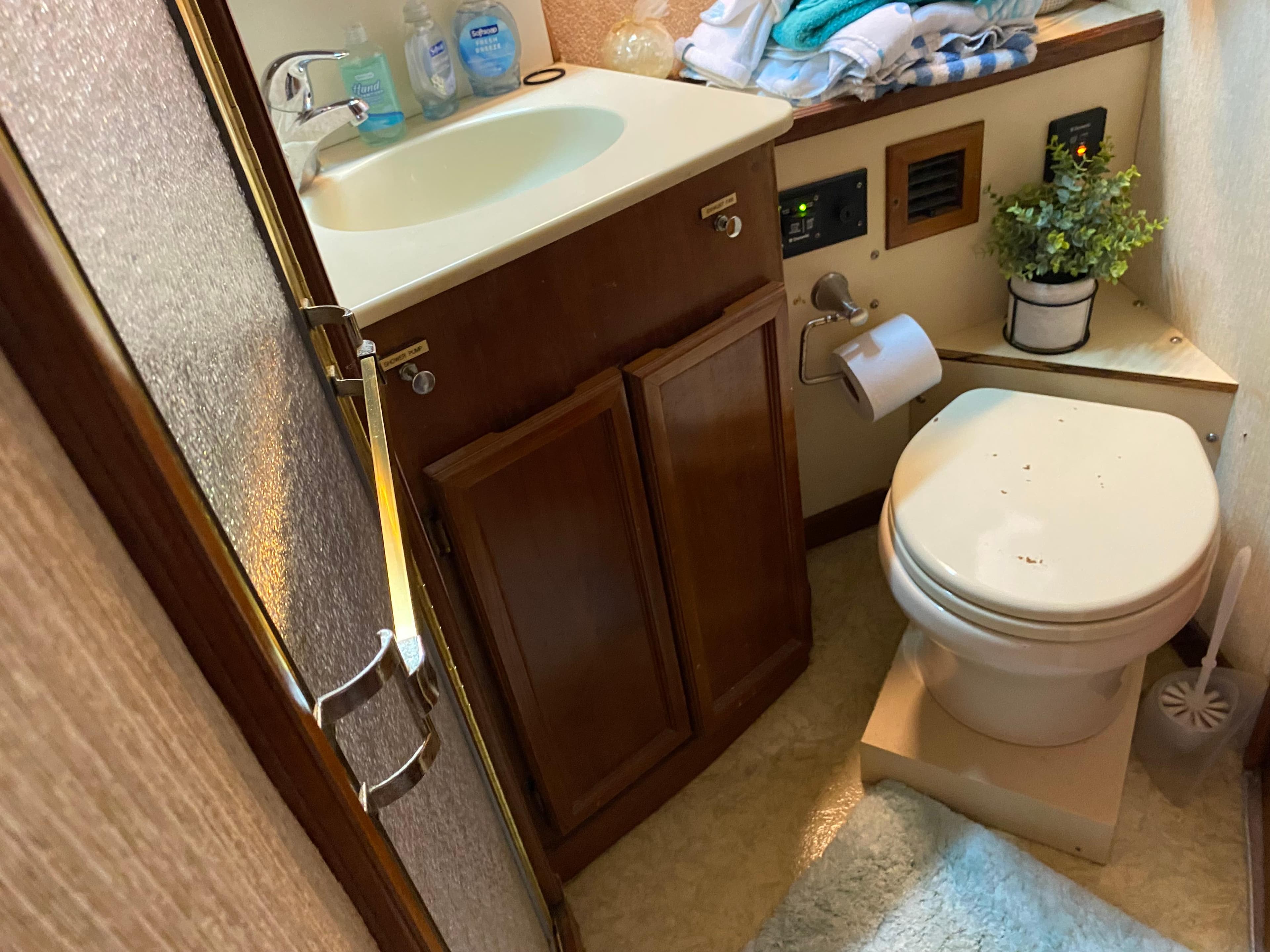Bathroom interior of 1990 Egg Harbor 42 Golden Egg yacht, featuring sink and toilet.