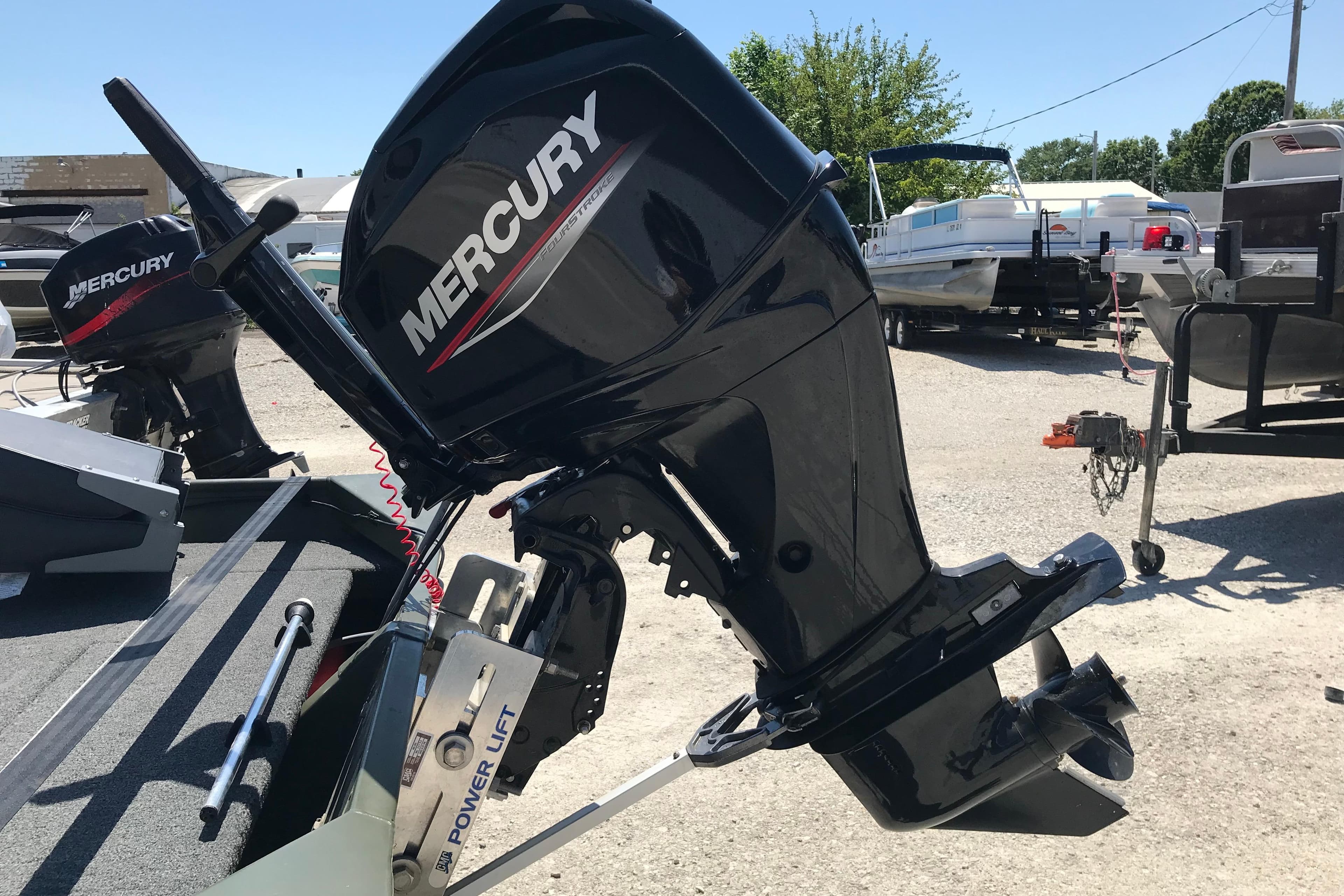 1992 Alweld 1856VV boat with Mercury outboard motor in a marina setting.