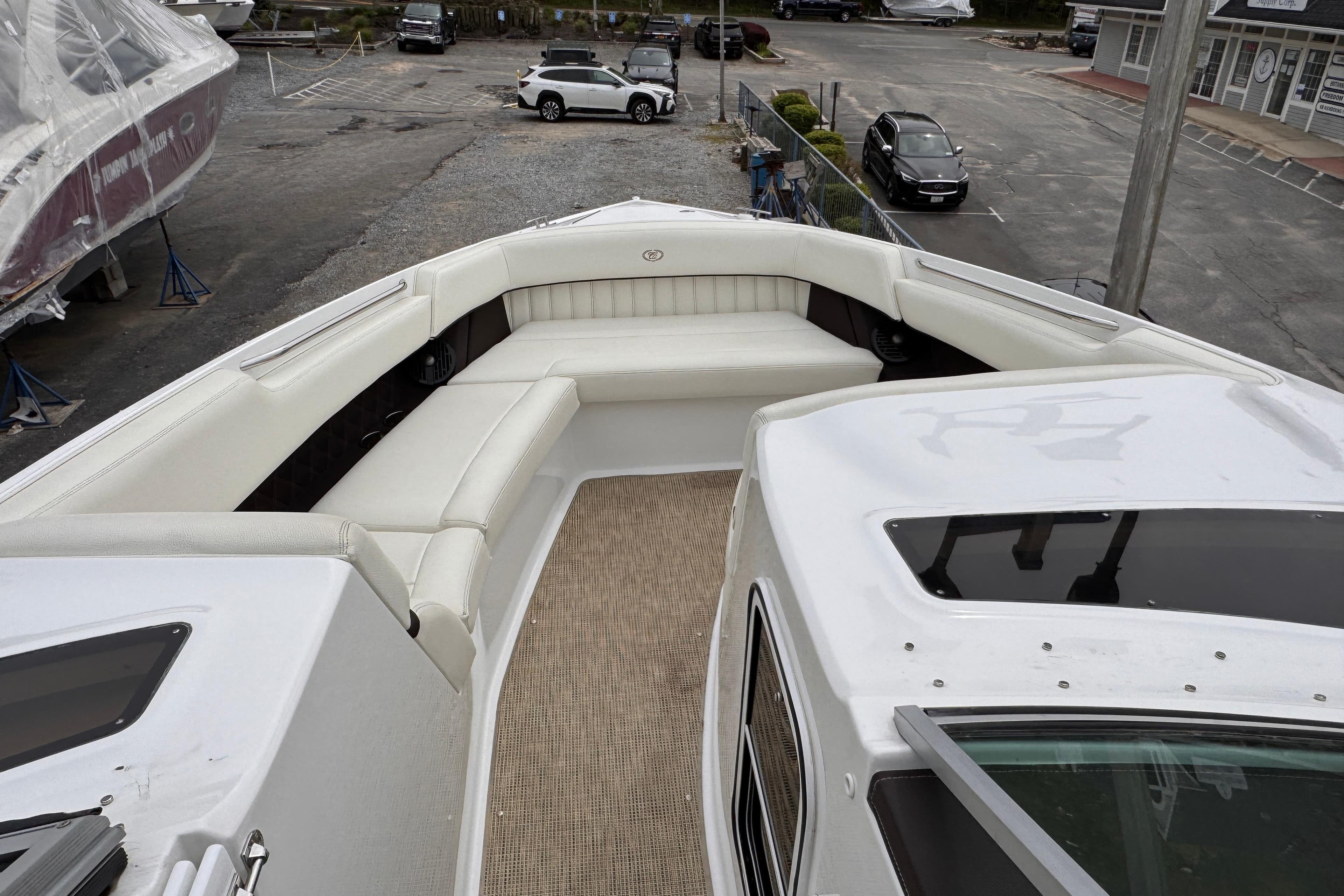 2018 Cobalt R35 boat with spacious white seating area, parked in a marina.