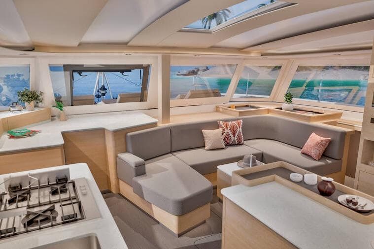 Luxurious interior of 2026 Fountaine Pajot FP48 Catamaran with modern seating and panoramic windows.