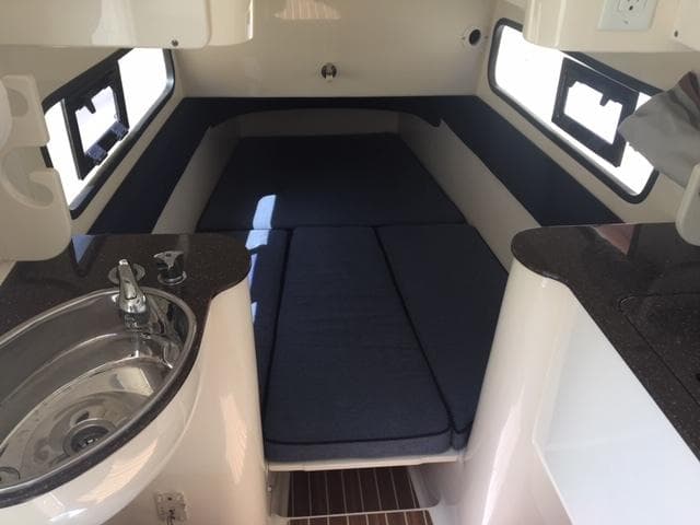 2016 Scout 350 LXF cabin interior with bed, sink, and windows.