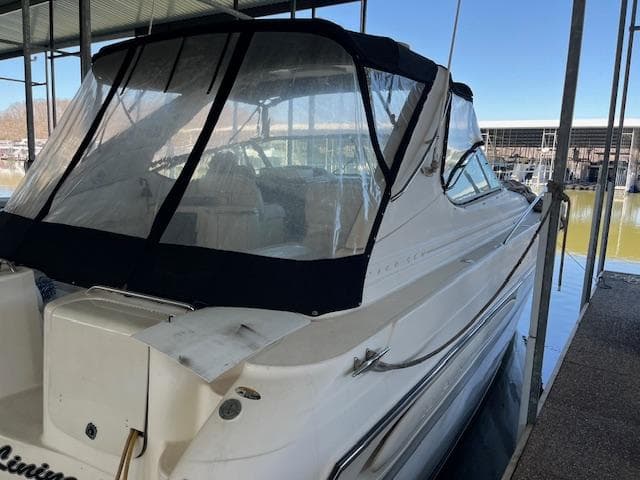 1998 Maxum 4100 SCR boat docked under a covered marina.