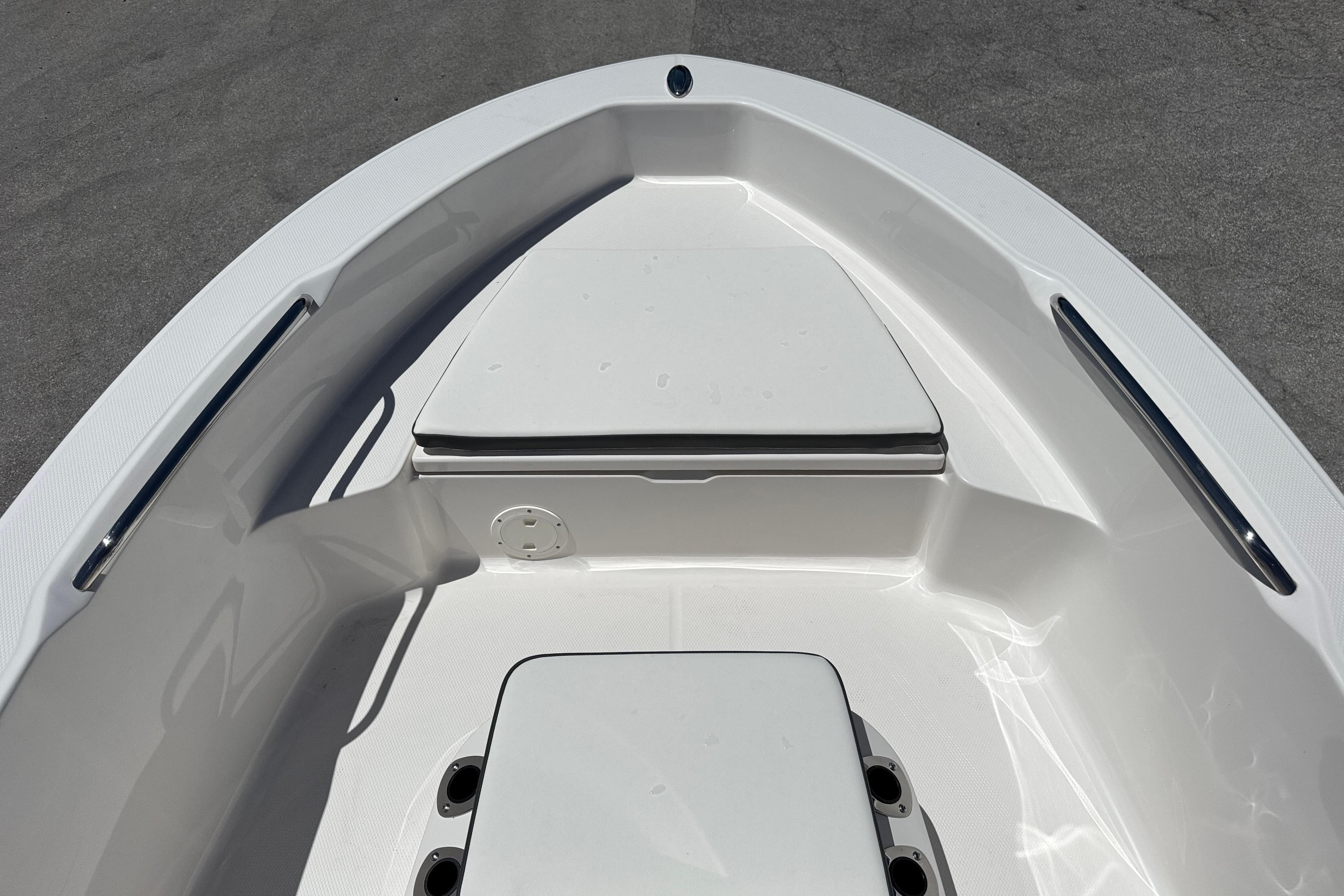 2025 Robalo R160 Center Console boat interior, featuring sleek white seating and storage compartments.