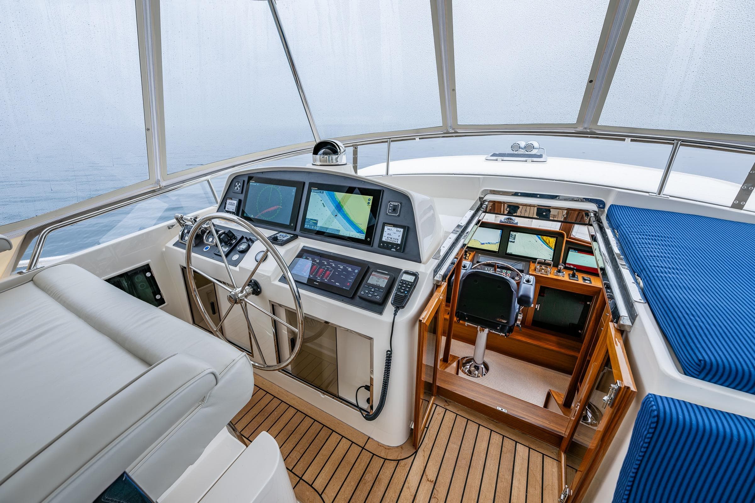 Pilothouse interior of 2026 Fleming 55 yacht with navigation equipment and seating.