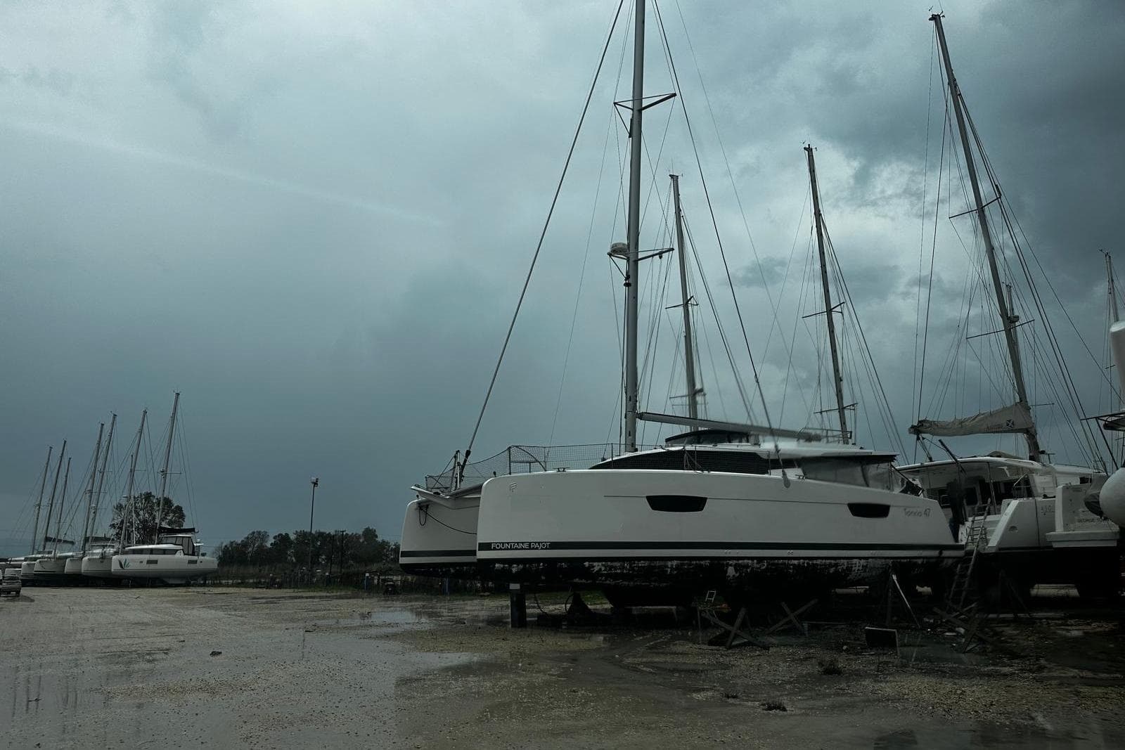2022 Fountaine Pajot Tanna 47 catamaran on land under cloudy skies.