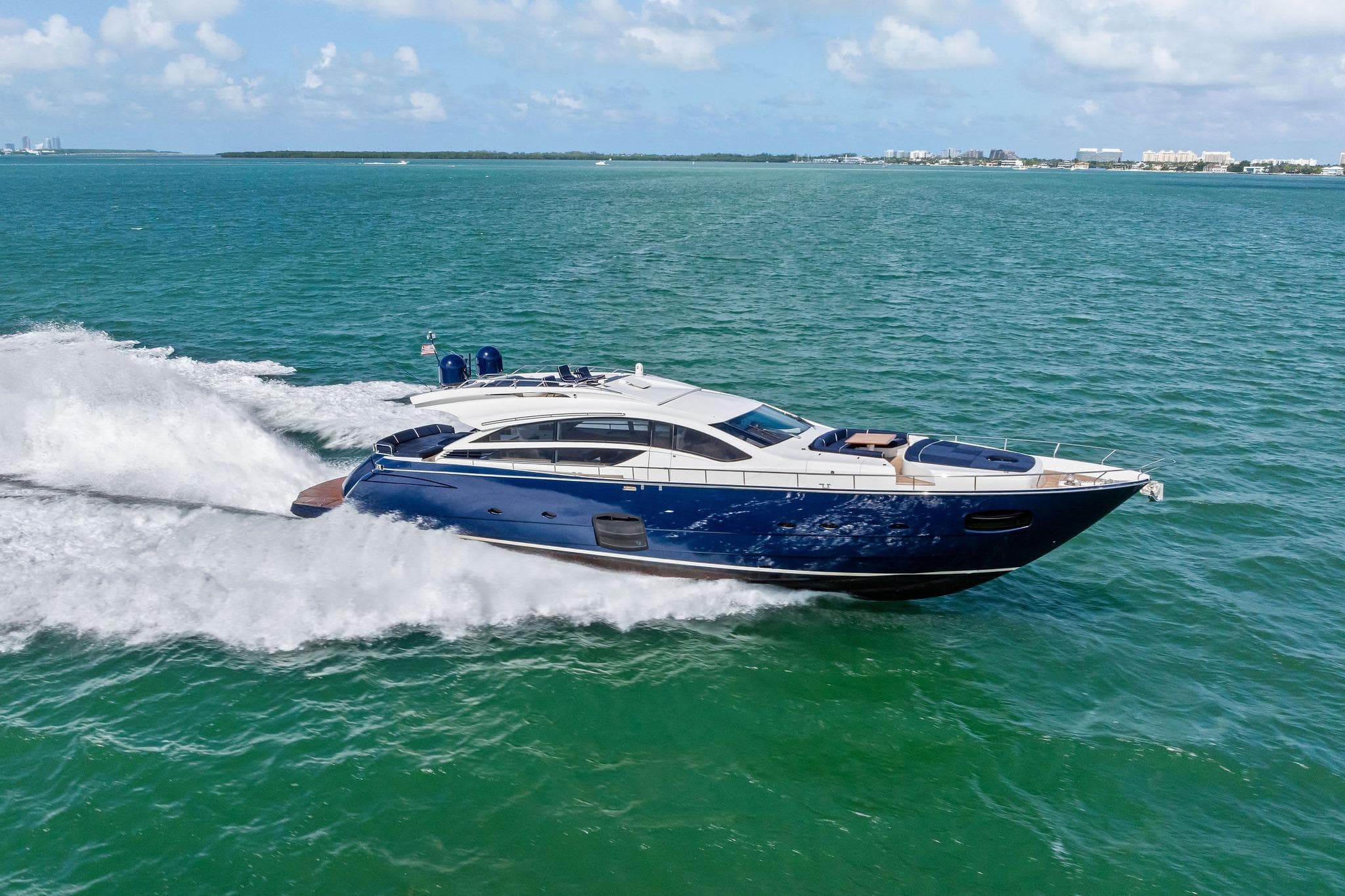 Luxurious 2013 Pershing 82 yacht cruising on open sea under clear skies.