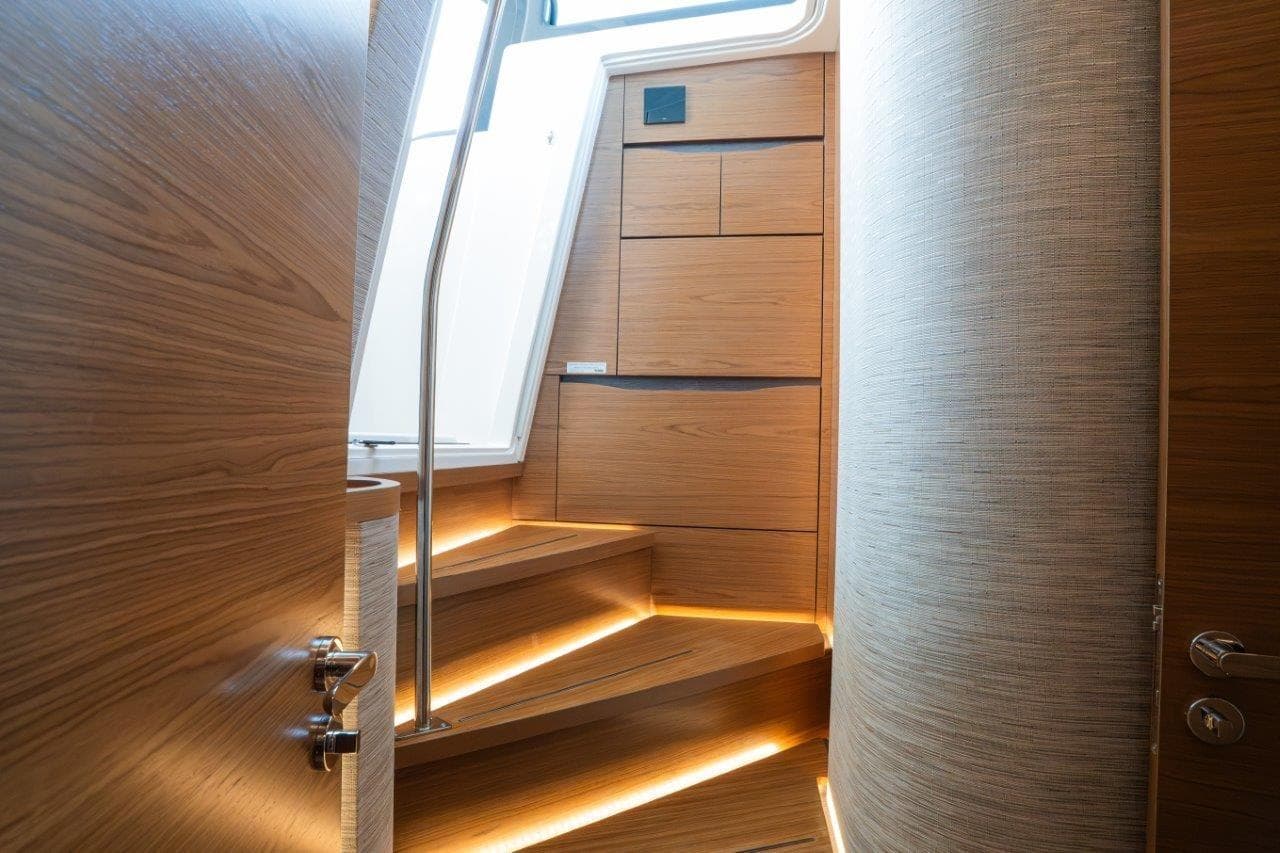 Interior of 2026 Tiara Yachts 56 LS, featuring elegant wooden stairs and modern design.