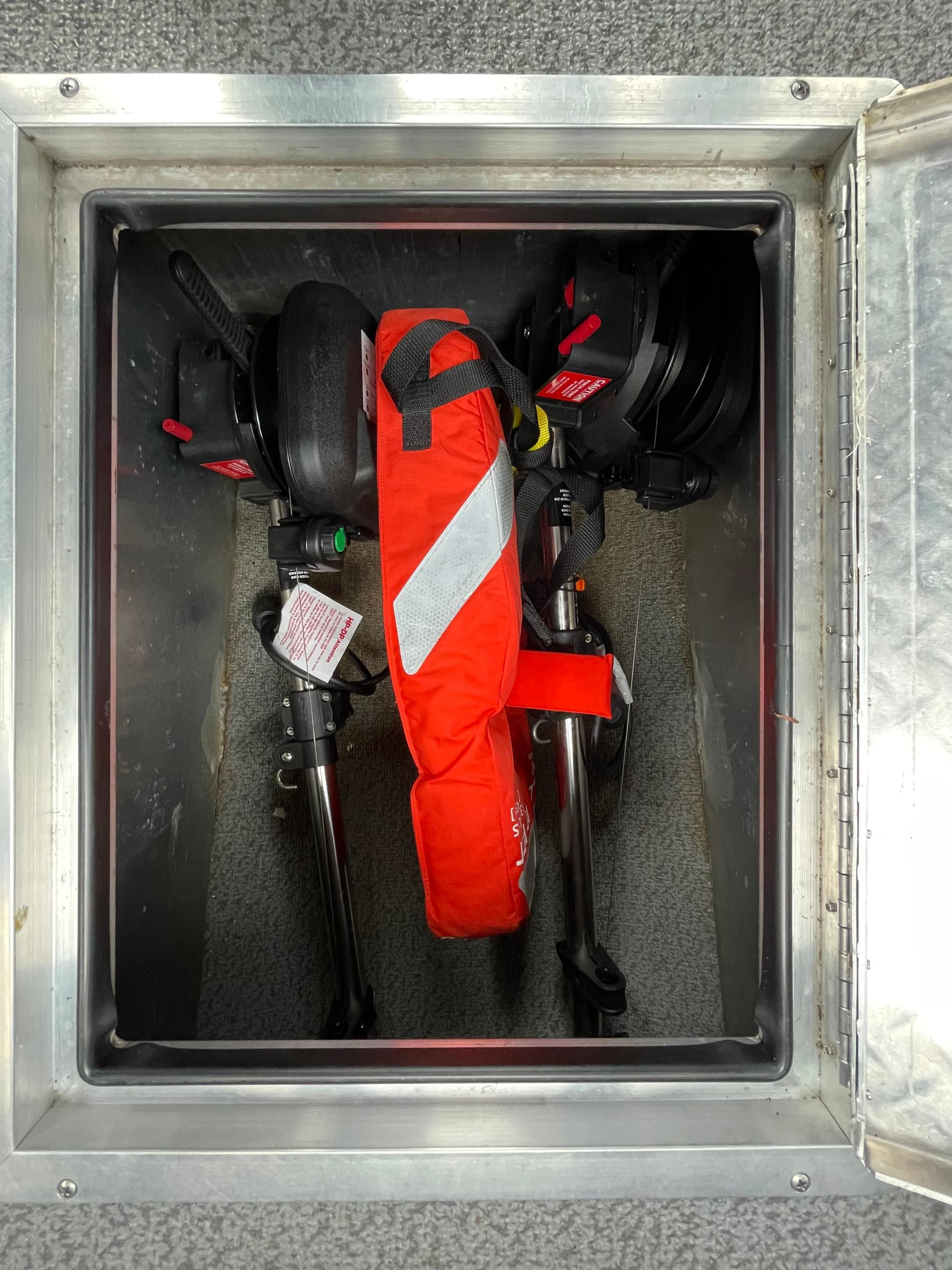Storage compartment in 2021 Thunder Jet 210 Luxor Limited with safety equipment and accessories.