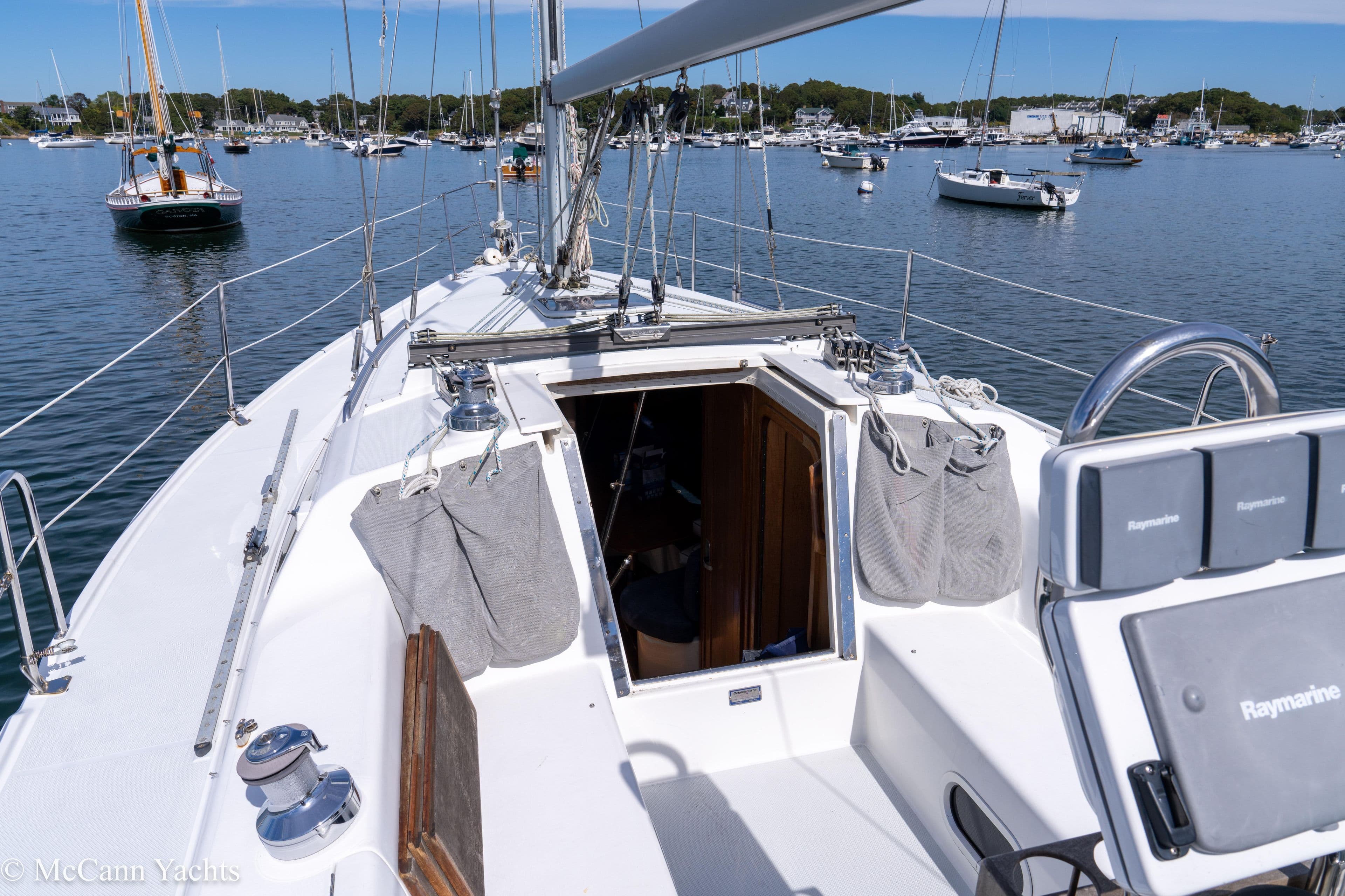 Sailboat deck view of 2003 Catalina 320, moored in a scenic harbor.