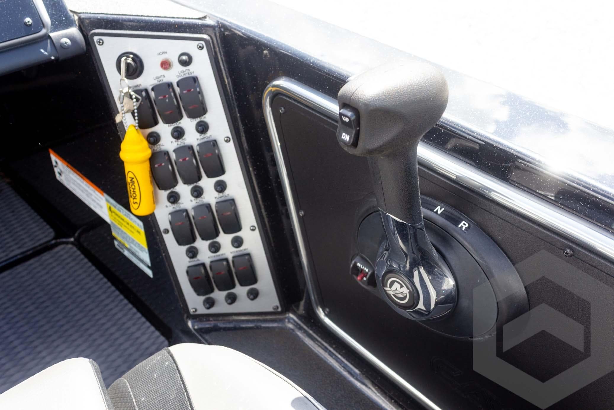 Control panel of 2025 Caymas CX 18 SS boat with gear lever and switches.