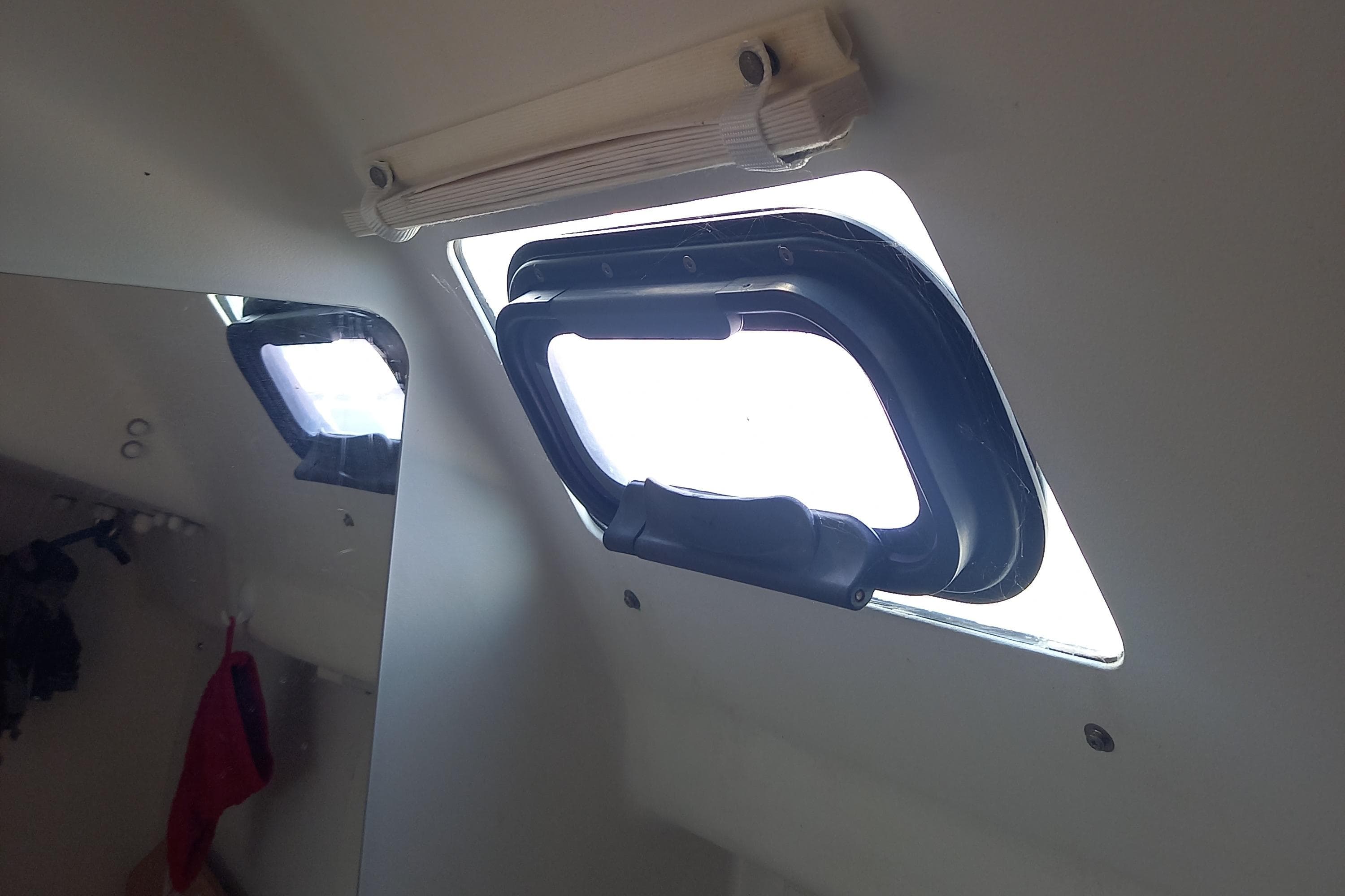 Interior view of a 2017 Pogo 1250 yacht showing an open porthole window.