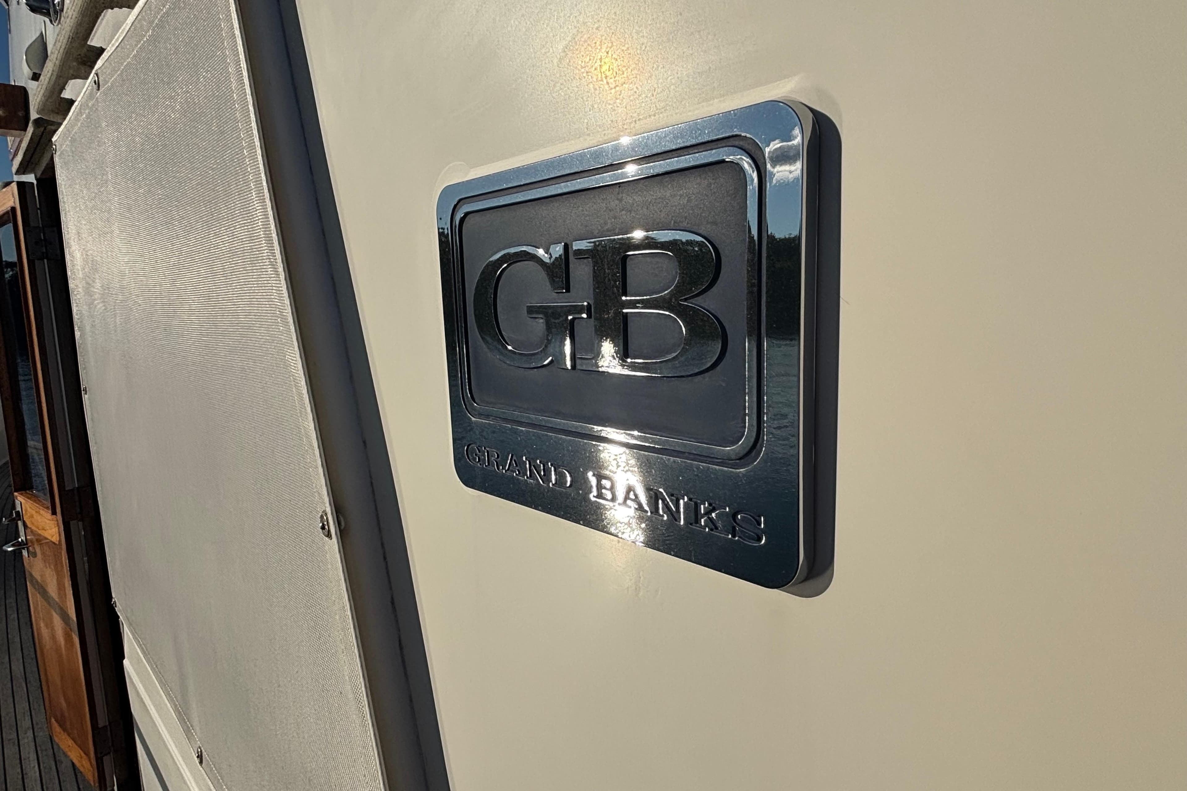 1989 Grand Banks 46 Classic yacht emblem on exterior wall.