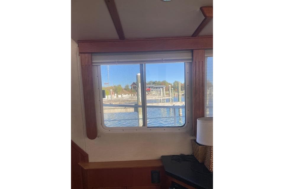 Interior view from a 2006 Nordic Tug 42, showcasing a window with a marina view.