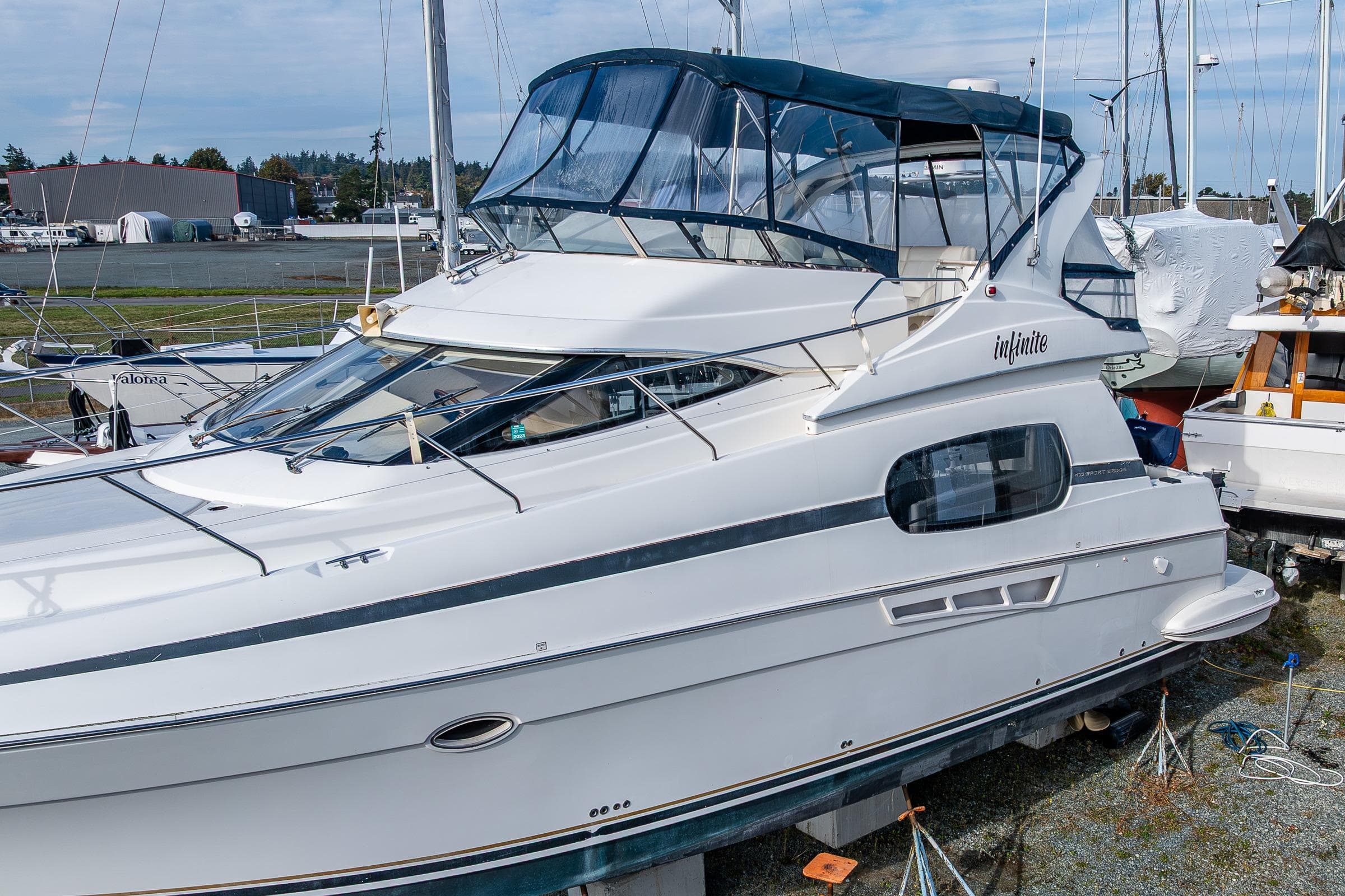 2001 Silverton 410 Sport Bridge yacht docked, featuring sleek design and spacious upper deck.