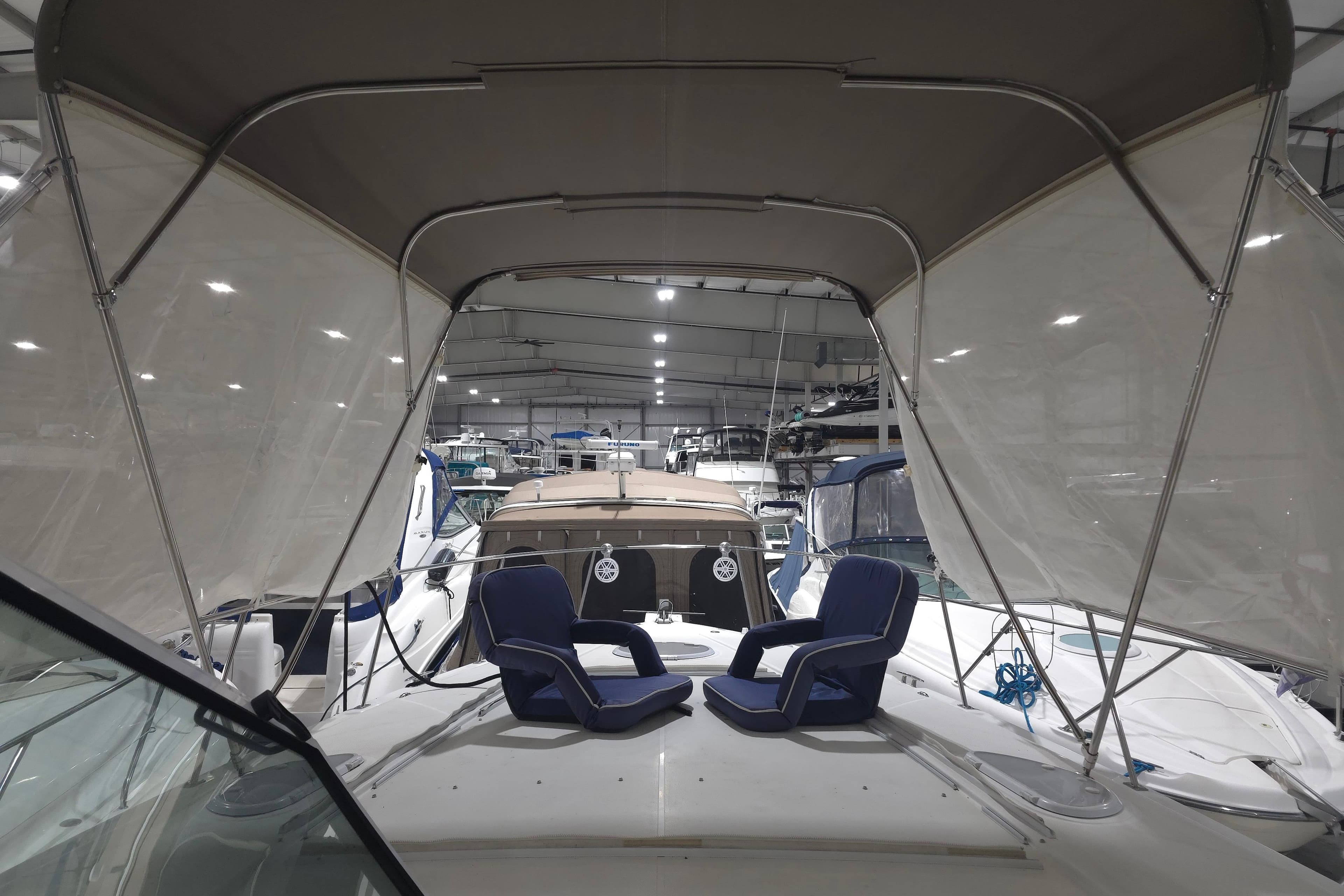 2008 Cruisers Yachts 390 Sports Coupe interior with seating under canopy in marina.