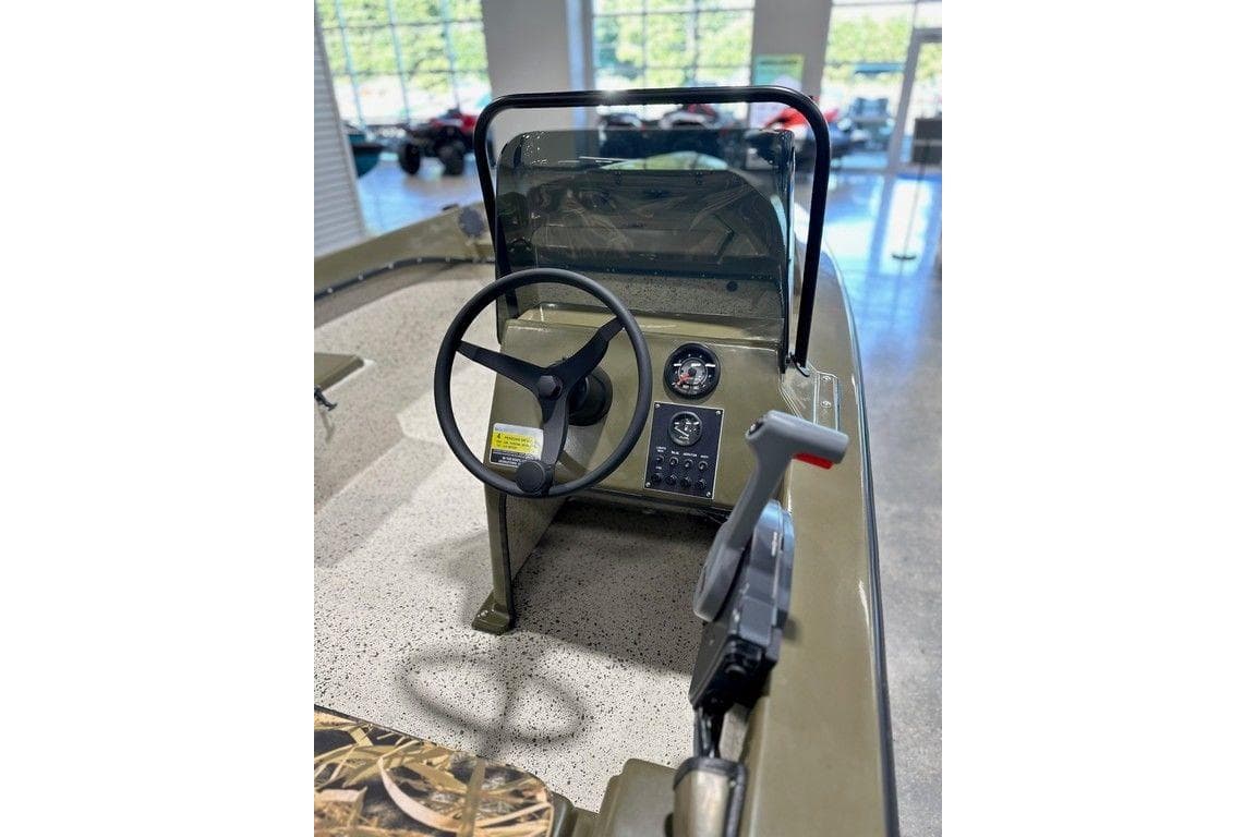 2026 Mi Tide 1602 CC boat console with steering wheel and control panel.