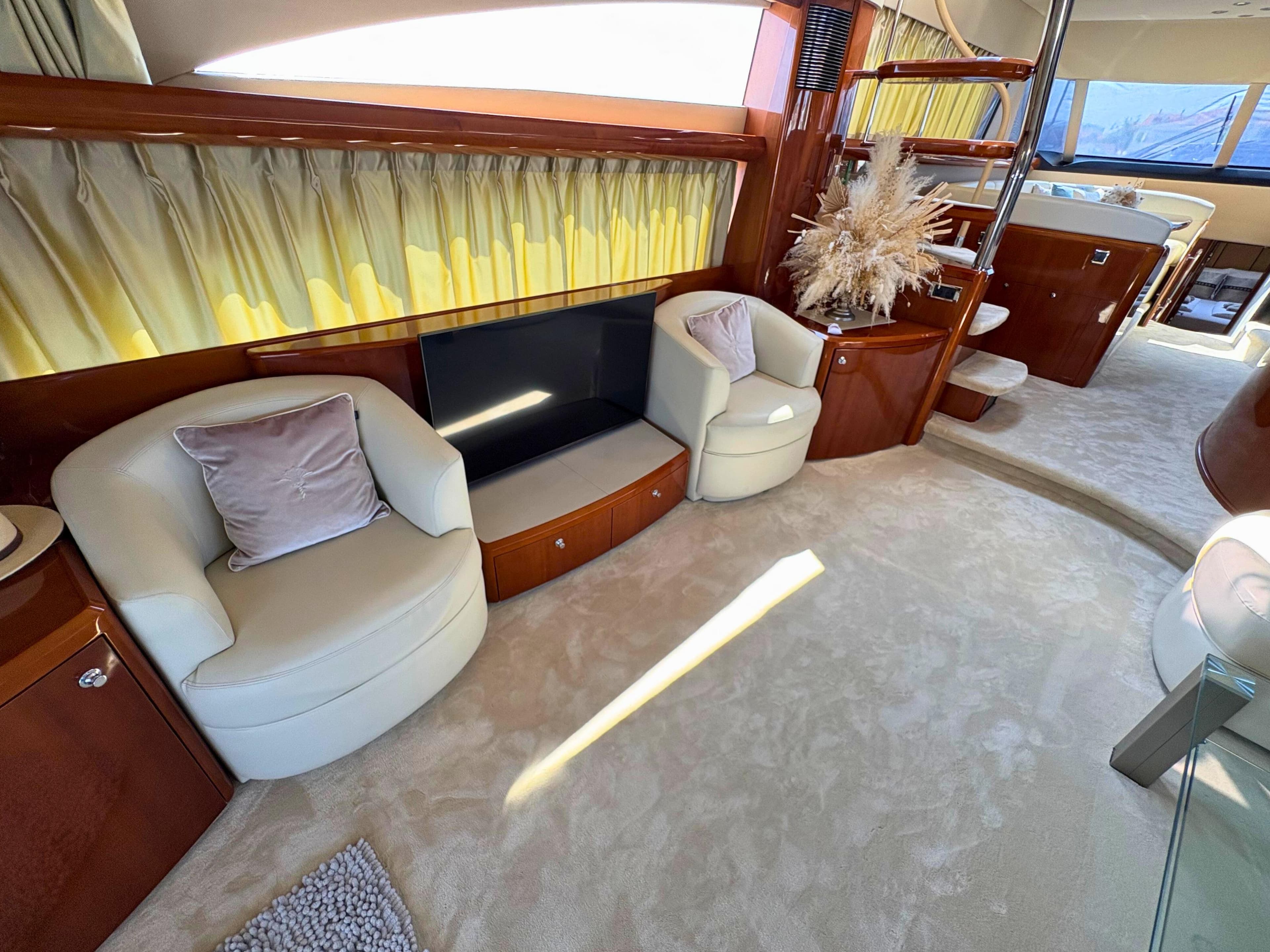 Luxurious interior of 2007 Princess 21M yacht with plush seating and elegant decor.