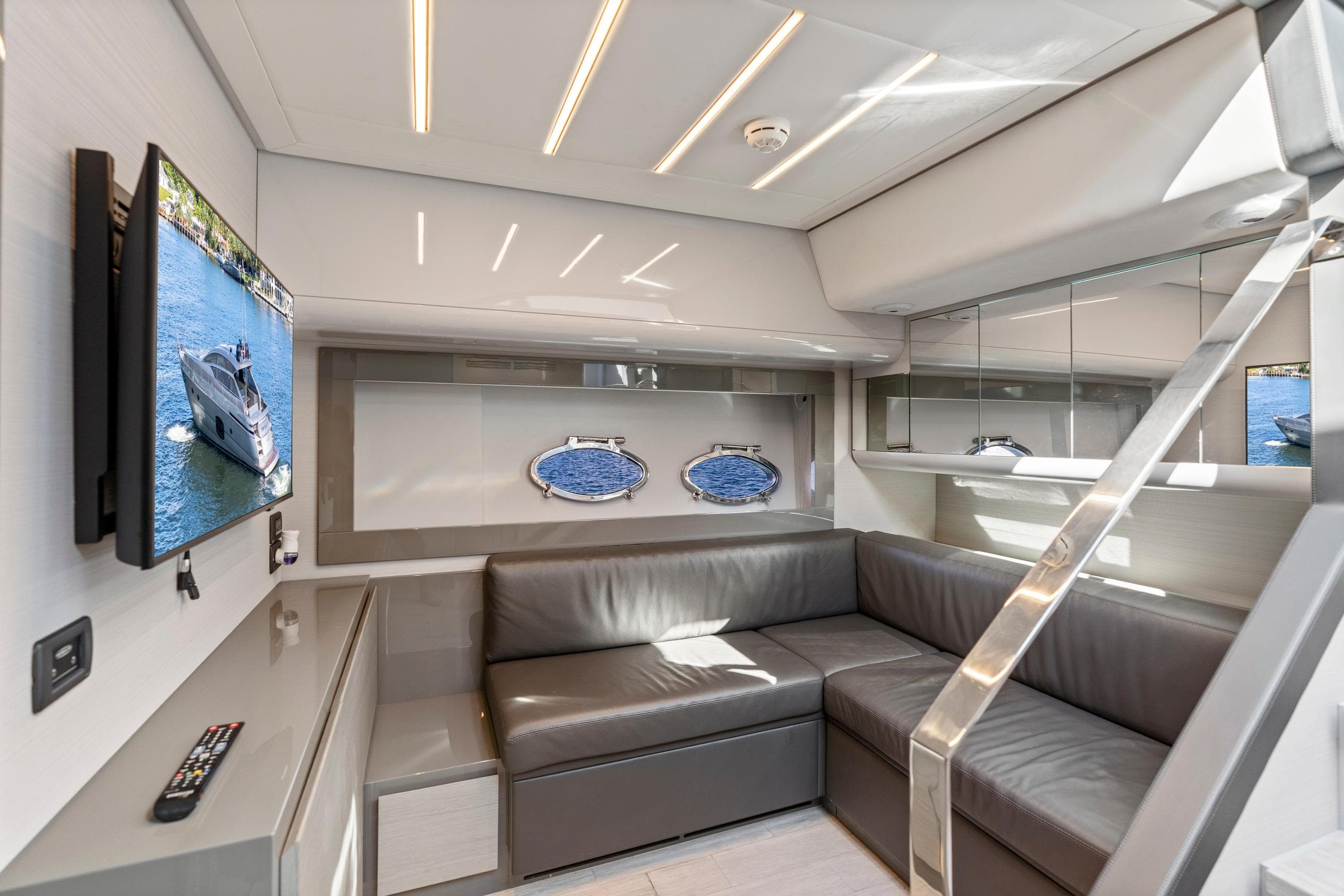 Luxurious interior of 2016 Pershing 62' yacht with modern seating and TV.
