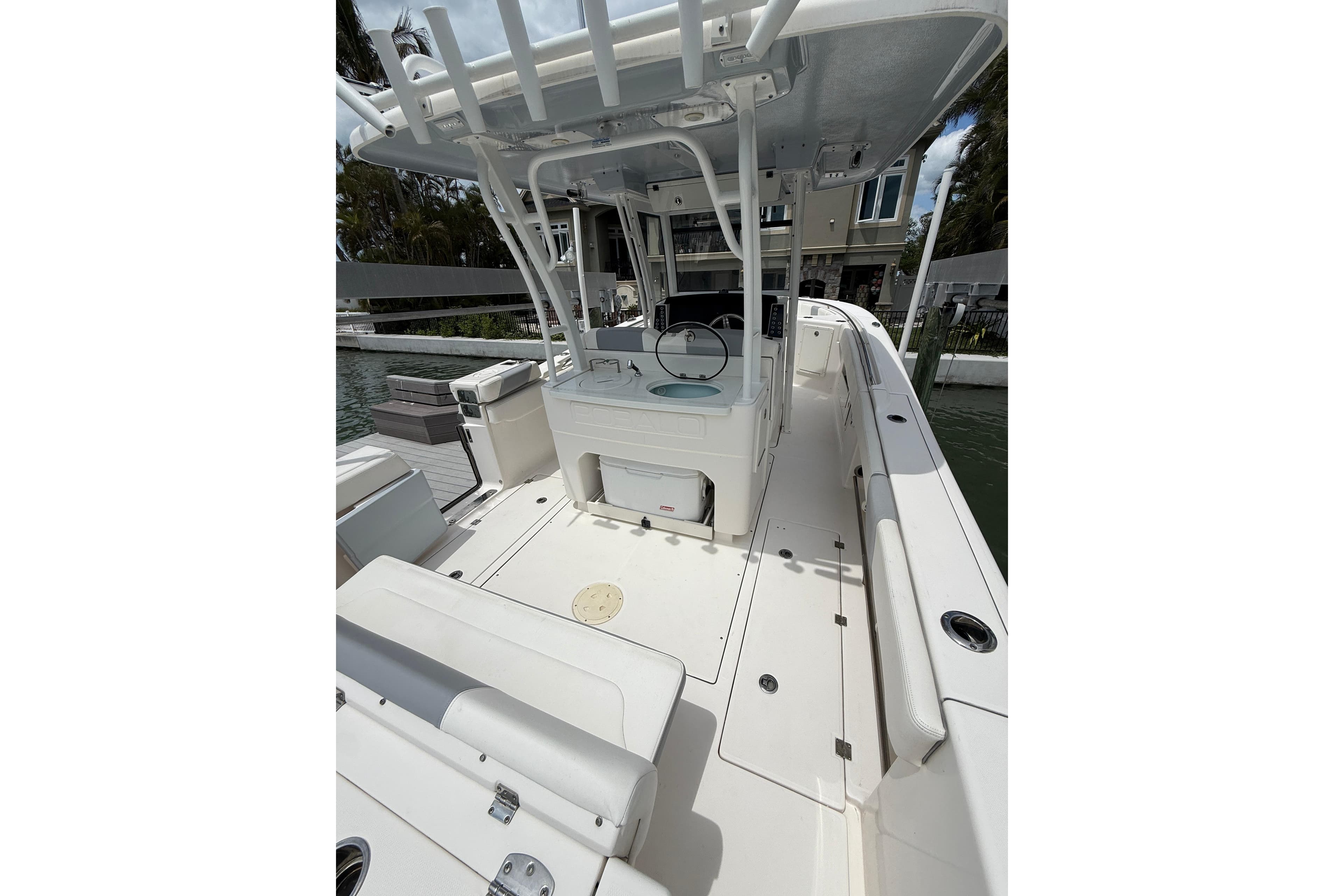 2022 Robalo R302 Center Console boat interior with seating and console, docked by water.