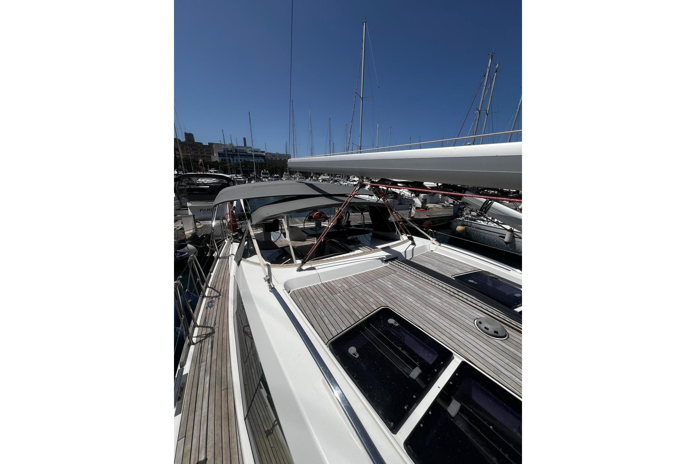 2015 Bavaria Vision 46 yacht docked in marina under clear blue sky.