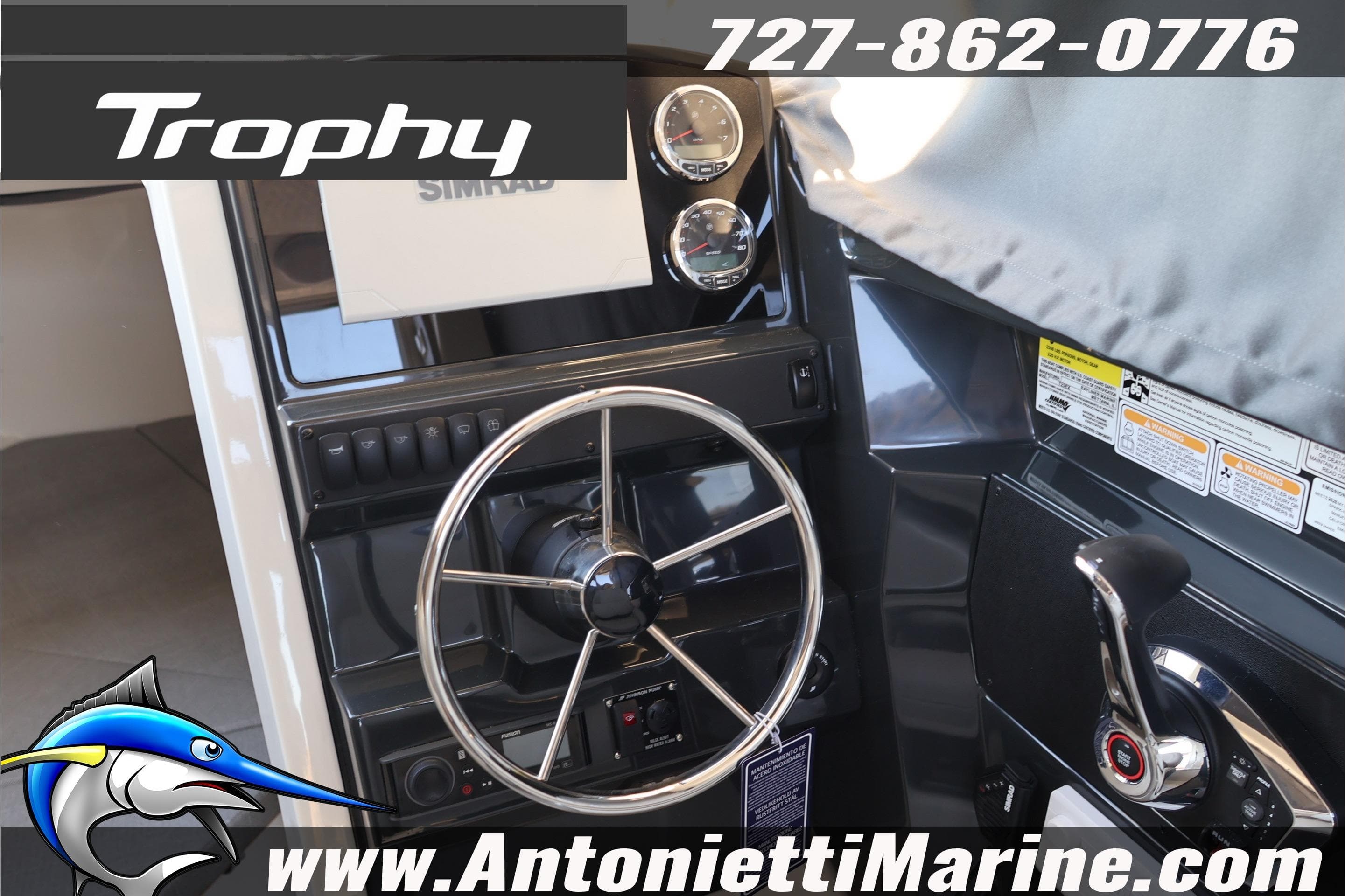 2026 Bayliner Trophy T23 Explorer helm with steering wheel and controls, featuring Simrad electronics.