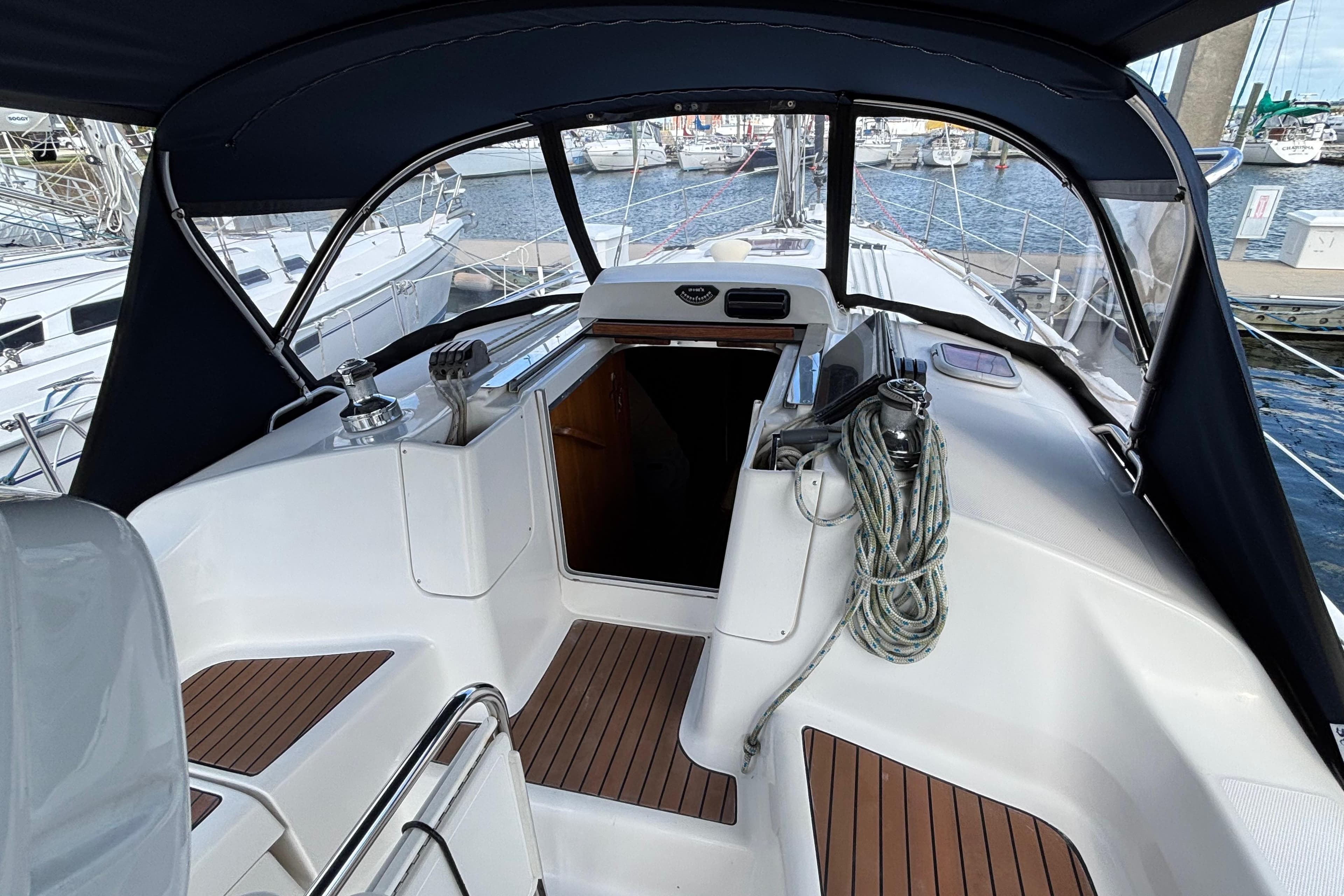 2006 Hunter 38 sailboat cockpit with wood accents and marina view.