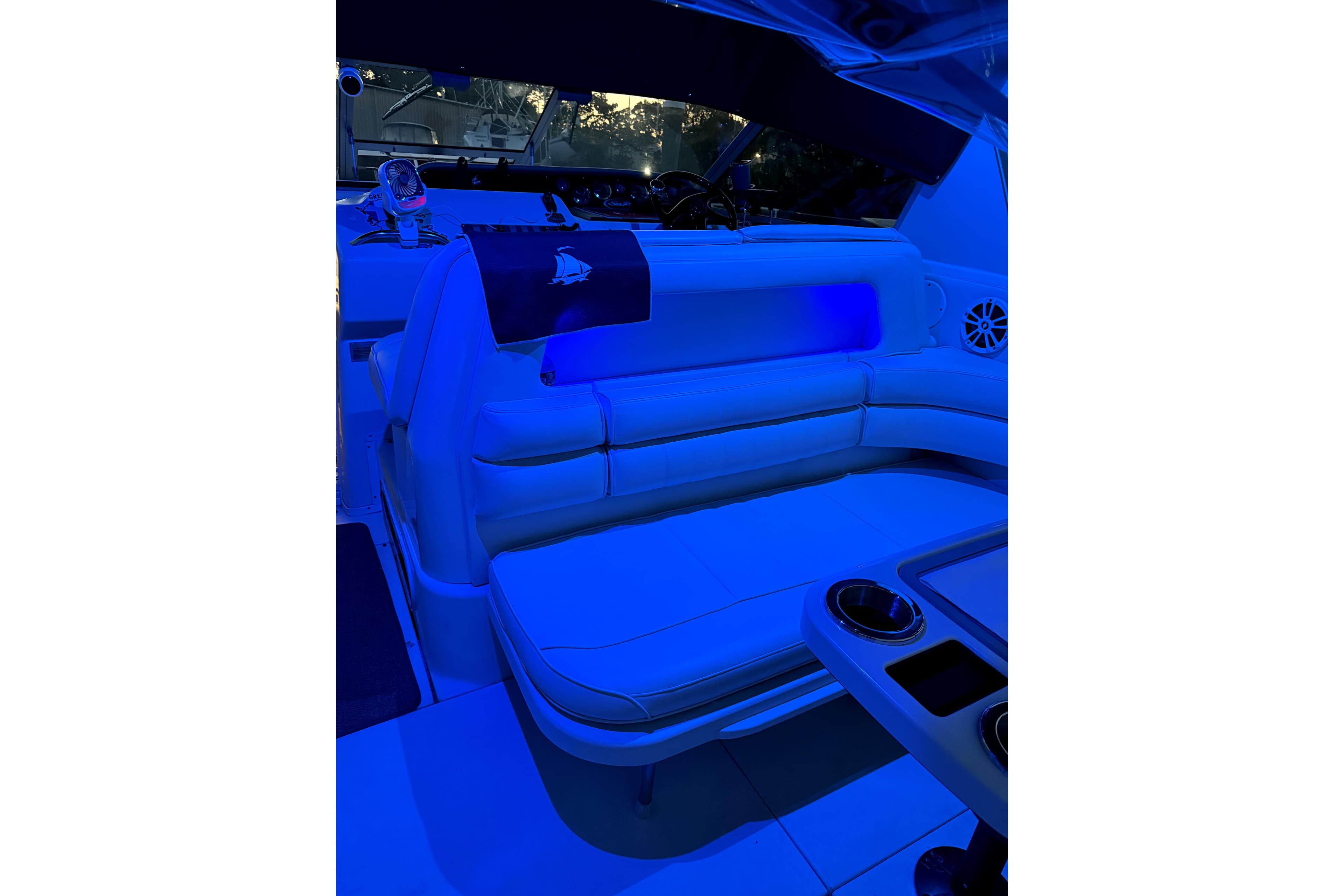 Interior of 1994 Sea Ray 300 Sundancer with blue ambient lighting and seating area.