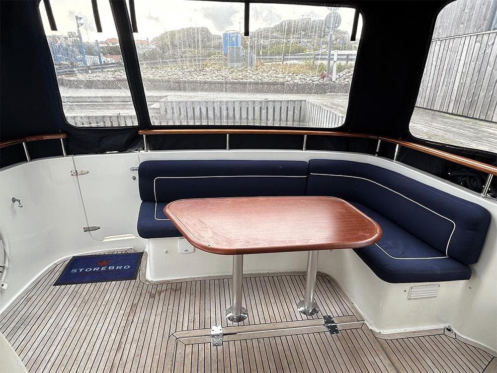 2014 Storebro 435 Commander yacht interior with blue seating and wooden table.