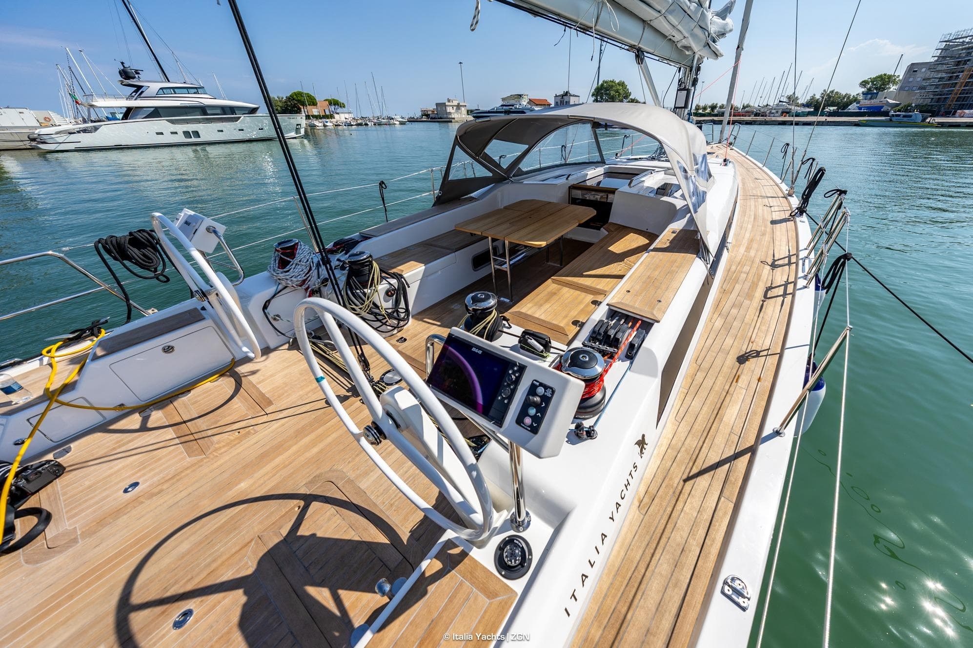 Italia Yachts IY 16.98, 2026 model, luxury sailboat docked in a marina.